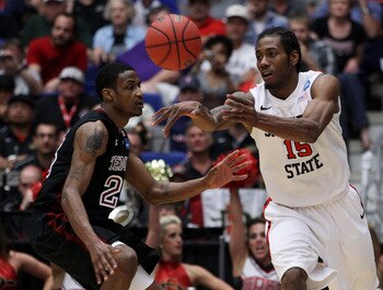 TUCSON, AZ - MARCH 19: Kawhi Leonard #15 of the San Diego State Aztecs passes the ball past Ramone Moore #23 of the Temple Owls during the third round of the 2011 NCAA men's basketball tournament at McKale Center on March 19, 2011 in Tucson, Arizona. (P TUCSON, AZ - MARCH 19: Kawhi Leonard #15 of the San Diego State Aztecs passes the ball past Ramone Moore #23 of the Temple Owls during the third round of the 2011 NCAA men's basketball tournament at McKale Center on March 19, 2011 in Tucson, Arizona. (P