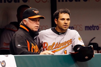 ST. PETERSBURG, FL - MAY 14:  Manager Buck Showalter of the Baltimore Orioles talks with Brian Roberts #1 during the game against the Tampa Bay Rays at Tropicana Field on May 14, 2011 in St. Petersburg, Florida.  (Photo by J. Meric/Getty Images)