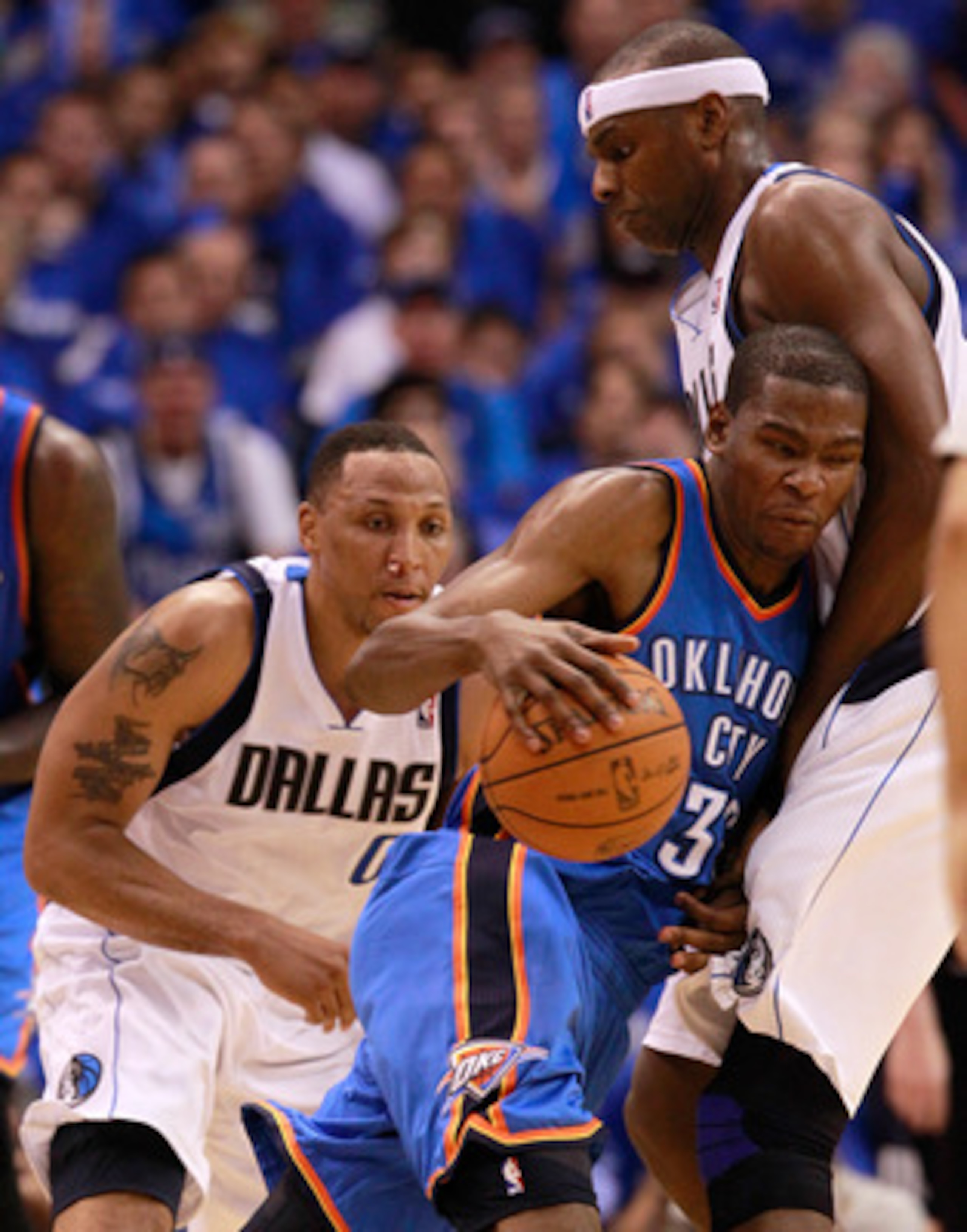 DALLAS, TX - MAY 17:  Kevin Durant #35 of the Oklahoma City Thunder moves the ball into Brendan Haywood #33 of the Dallas Mavericks as Shawn Marion #0 of the Mavericks is behind Durant in the second half in Game One of the Western Conference Finals during