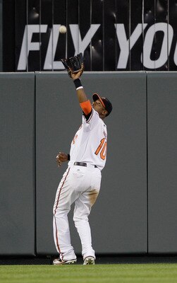 BALTIMORE, MD - MAY 12:  Center fielder Adam Jones #10 of the Baltimore Orioles makes a catch against the Seattle Mariners at Oriole Park at Camden Yards on May 12, 2011 in Baltimore, Maryland.  (Photo by Rob Carr/Getty Images)