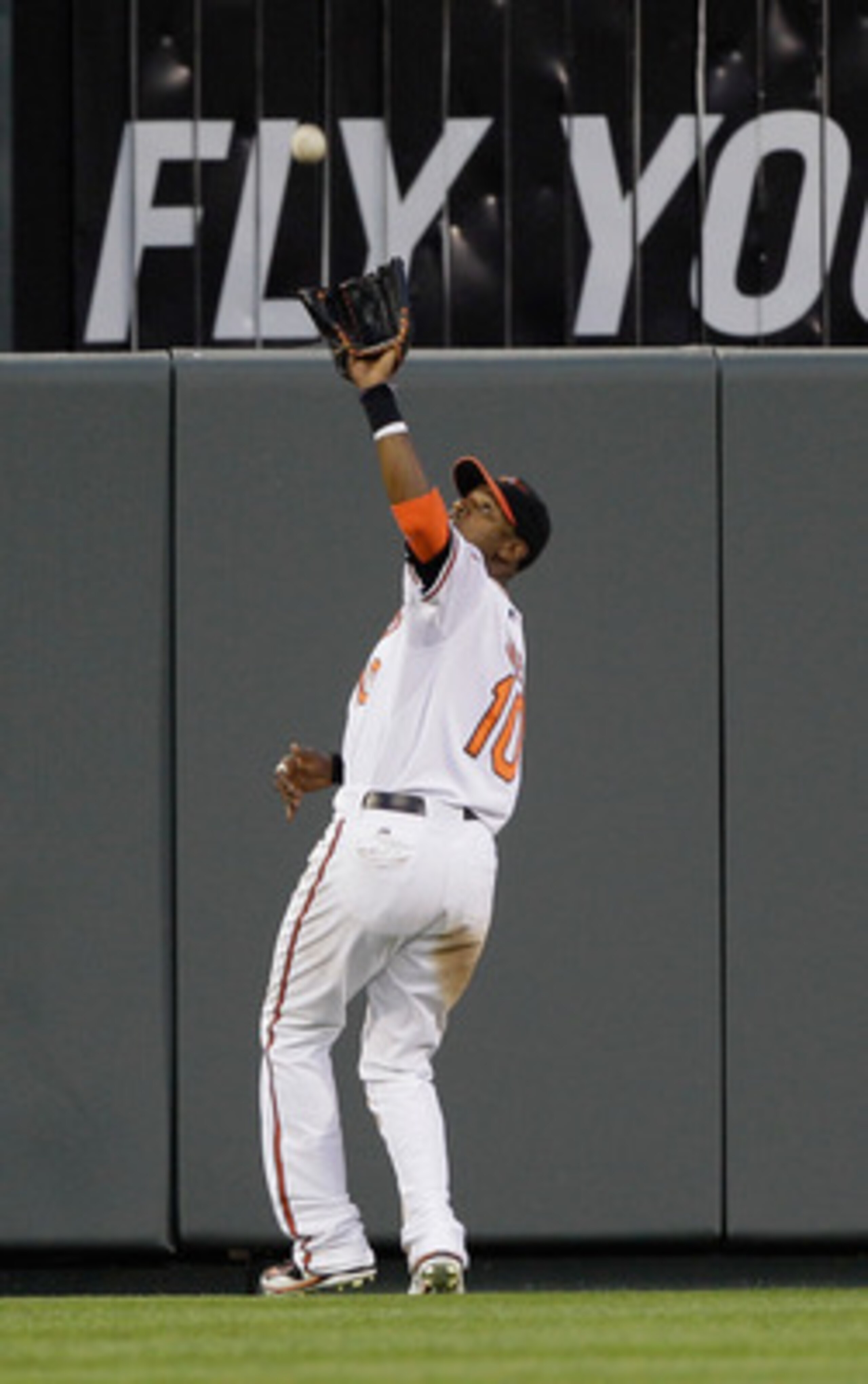 BALTIMORE, MD - MAY 12:  Center fielder Adam Jones #10 of the Baltimore Orioles makes a catch against the Seattle Mariners at Oriole Park at Camden Yards on May 12, 2011 in Baltimore, Maryland.  (Photo by Rob Carr/Getty Images)