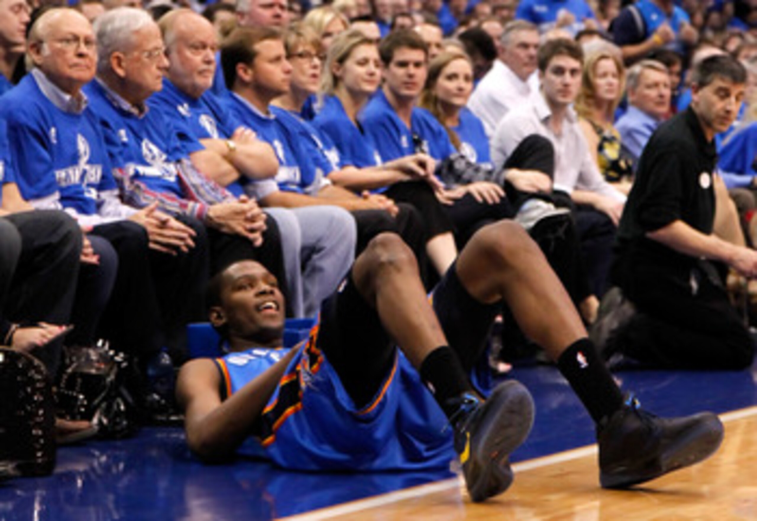 DALLAS, TX - MAY 17:  Kevin Durant #35 of the Oklahoma City Thunder reacts as he falls in front of the courtside seats in the first half while taking on the Dallas Mavericks in Game One of the Western Conference Finals during the 2011 NBA Playoffs at Amer