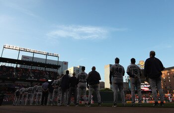 BALTIMORE, MD - MAY 12:  Members of the Seattle Mariners listen to the national anthem before the start of their game against the Baltimore Orioles at Oriole Park at Camden Yards on May 12, 2011 in Baltimore, Maryland.  (Photo by Rob Carr/Getty Images)