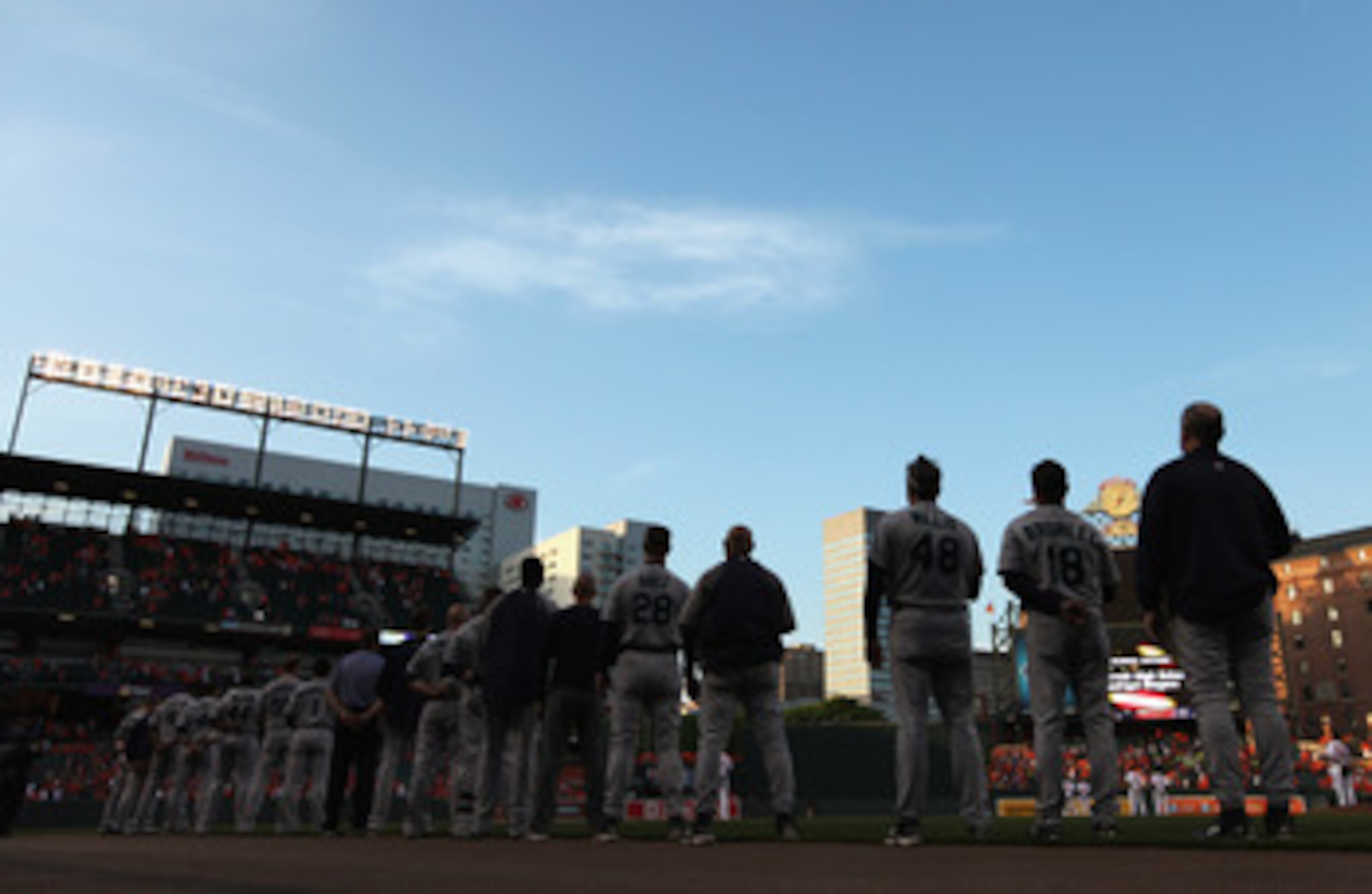 BALTIMORE, MD - MAY 12:  Members of the Seattle Mariners listen to the national anthem before the start of their game against the Baltimore Orioles at Oriole Park at Camden Yards on May 12, 2011 in Baltimore, Maryland.  (Photo by Rob Carr/Getty Images)