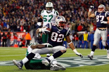 FOXBORO, MA - JANUARY 16:  Alge Crumpler #82 of the New England Patriots scores a touchdown against James Ihedigbo #44 of the New York Jets in the third quarter during their 2011 AFC divisional playoff game at Gillette Stadium on January 16, 2011 in Foxbo