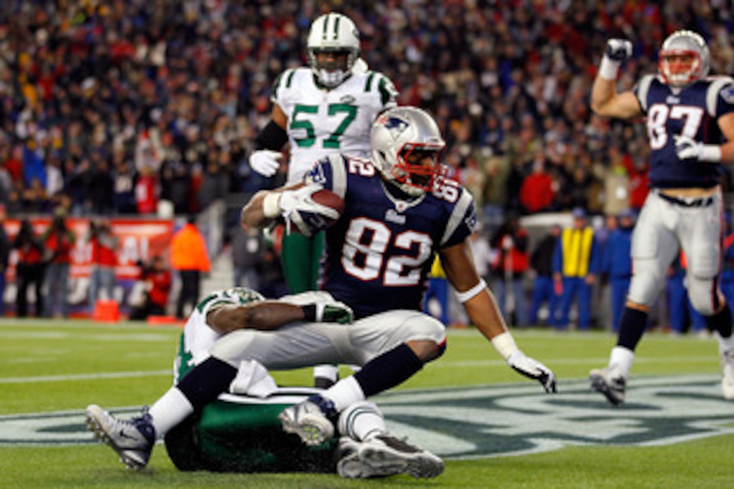 FOXBORO, MA - JANUARY 16:  Alge Crumpler #82 of the New England Patriots scores a touchdown against James Ihedigbo #44 of the New York Jets in the third quarter during their 2011 AFC divisional playoff game at Gillette Stadium on January 16, 2011 in Foxbo