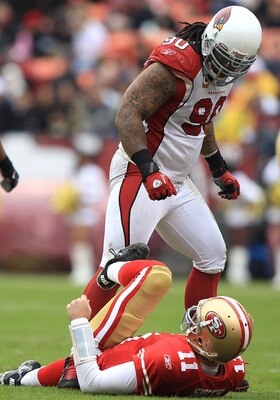 SAN FRANCISCO, CA - JANUARY 02:    Alex Smith #11 of the San Francisco 49ers is sacked by Darnell Dockett #90 of the Arizona Cardinals during an NFL game at Candlestick Park on January 2, 2011 in San Francisco, California.  (Photo by Jed Jacobsohn/Getty I