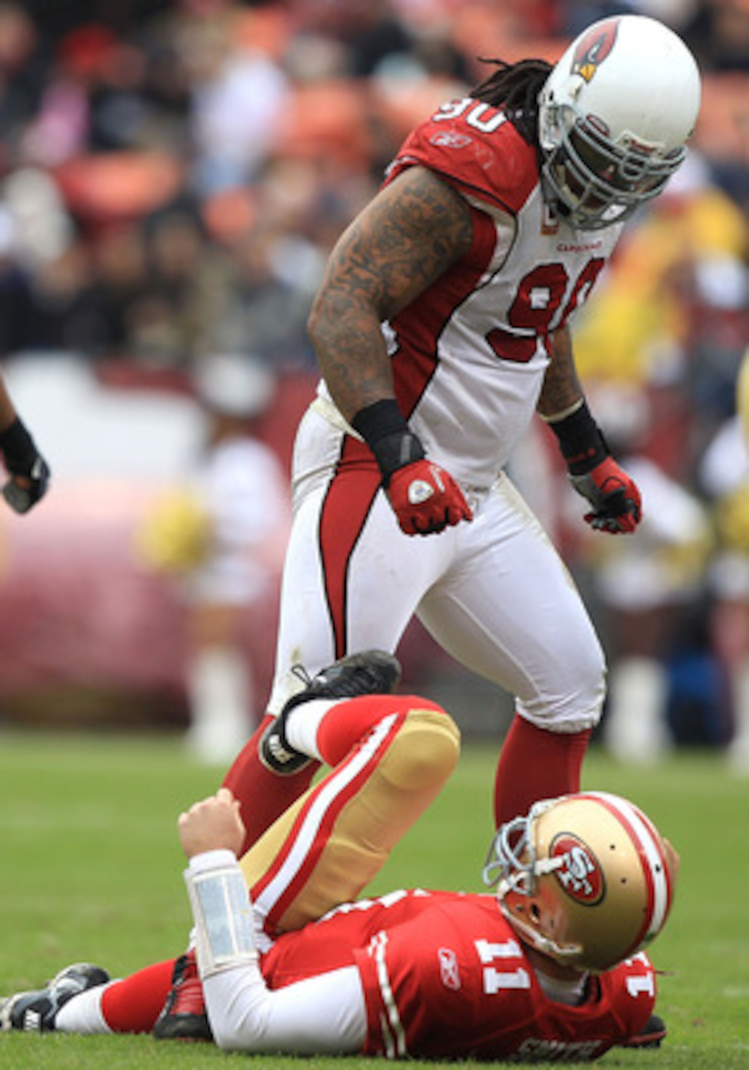 SAN FRANCISCO, CA - JANUARY 02:    Alex Smith #11 of the San Francisco 49ers is sacked by Darnell Dockett #90 of the Arizona Cardinals during an NFL game at Candlestick Park on January 2, 2011 in San Francisco, California.  (Photo by Jed Jacobsohn/Getty I