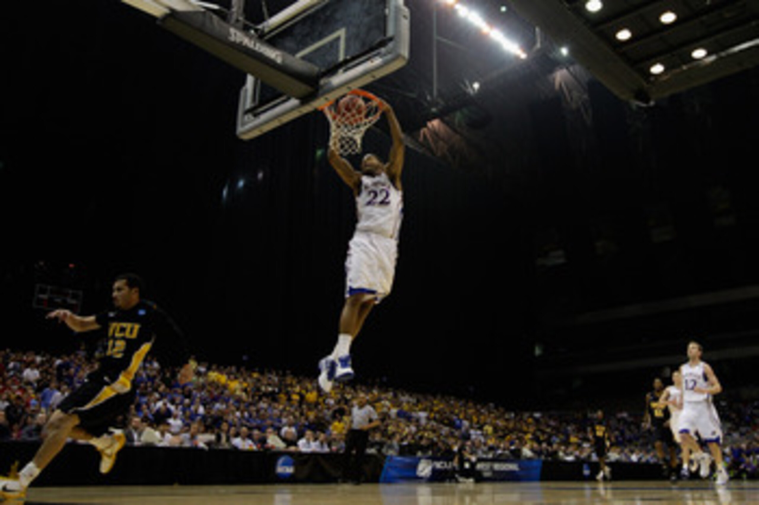 SAN ANTONIO, TX - MARCH 27:  Marcus Morris #22 of the Kansas Jayhawks dunks against the Virginia Commonwealth Rams during the southwest regional final of the 2011 NCAA men's basketball tournament at the Alamodome on March 27, 2011 in San Antonio, Texas.  