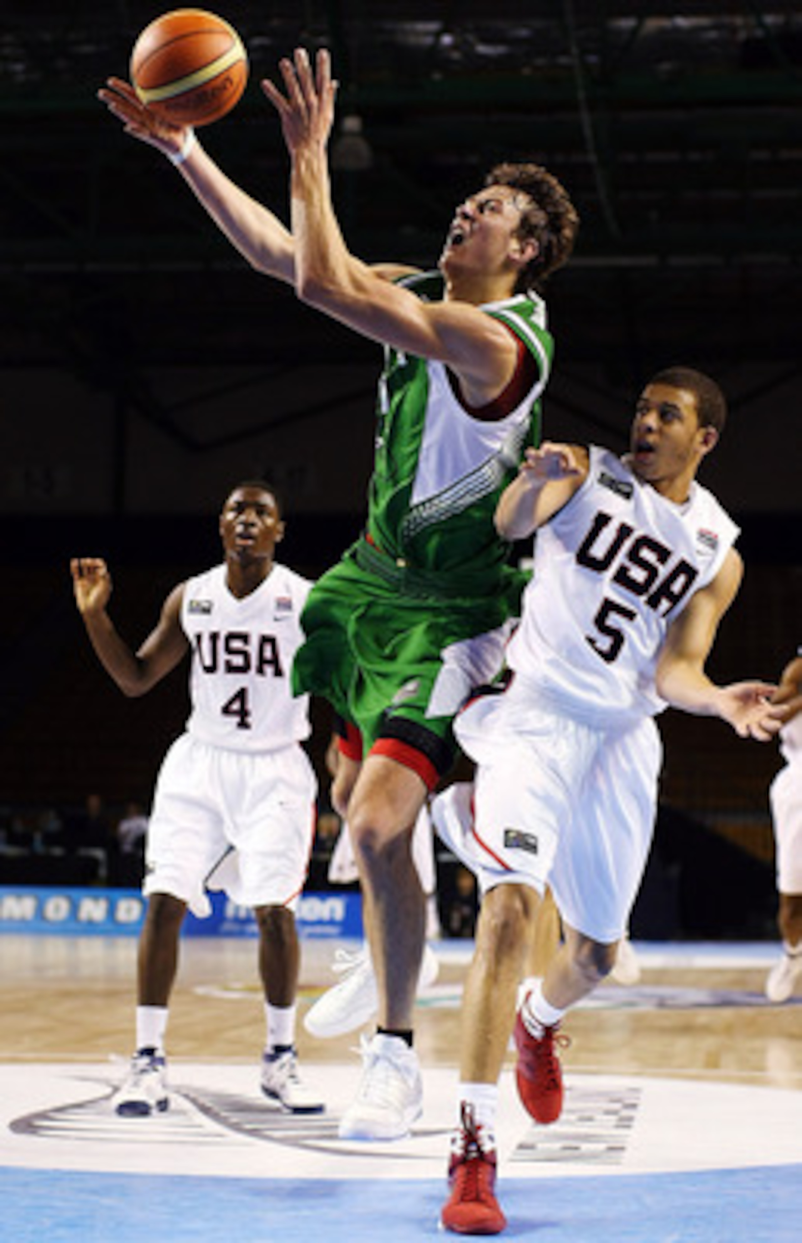 AUCKLAND, NEW ZEALAND - JULY 08:  Donatas Motiejunas of Lithuania takes the ball to the hoop as Seth Curry of the United States defends during the U19 Basketball World Championships match between the United States and Lithuania at North Shore Events Centr