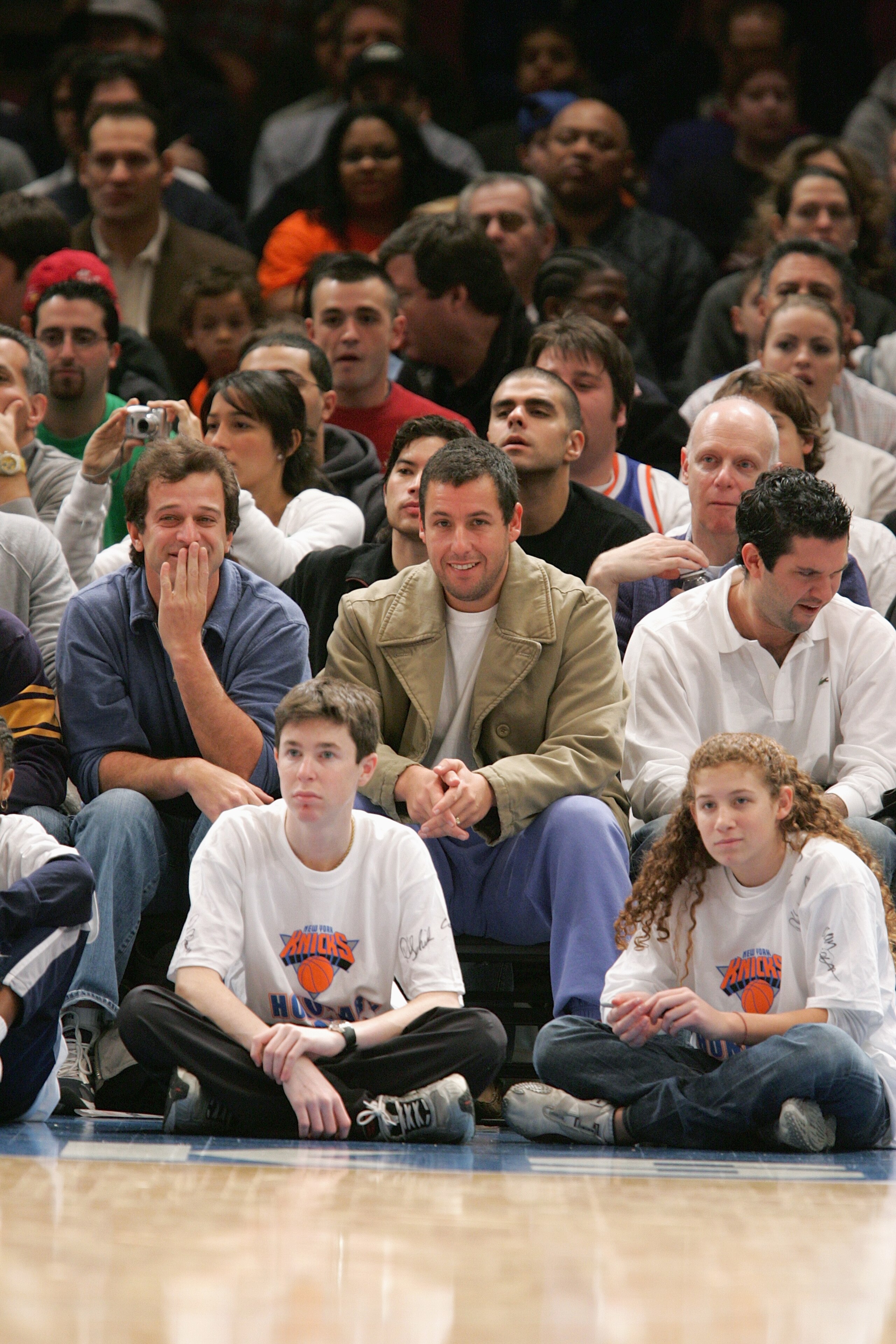 NEW YORK - DECEMBER 12:  New York Knicks fans Allen Covert (L) and Adam Sandler watch the game with the Denver Nuggets on December 12 2004 at Madison Square Garden in New York City, New York. The Knicks won 107-96. NOTE TO USER: User expressly acknowledge