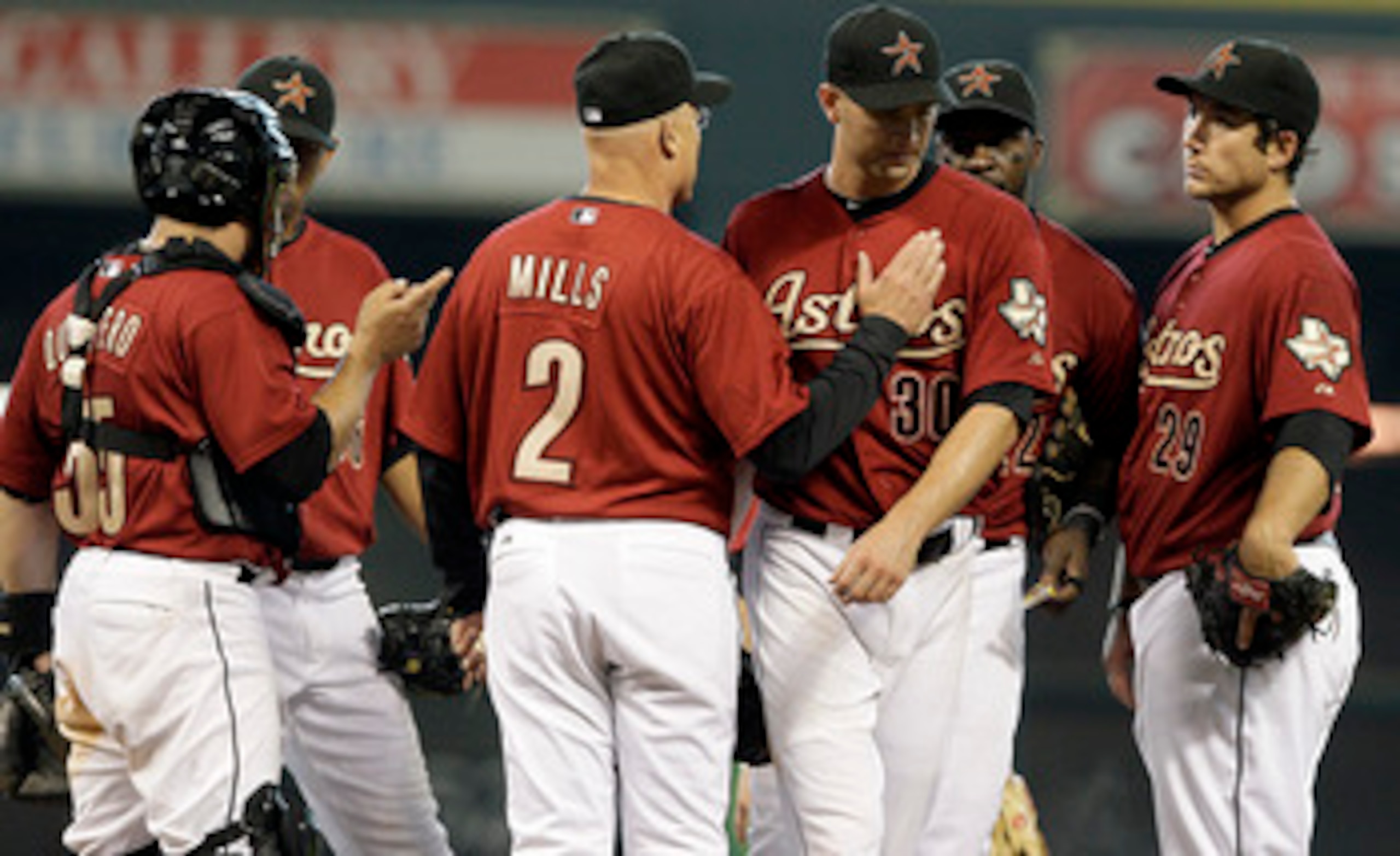 HOUSTON, TX - APRIL 10: Pitcher J.A. Happ #30 is tapped on the shoulder by Manager Brad Mills #2 of the Houston Astros after being removed after pitching seven point two inning in a MLB  baseball game on April 10, 2011 at Minute Maid Park in Houston, Texa