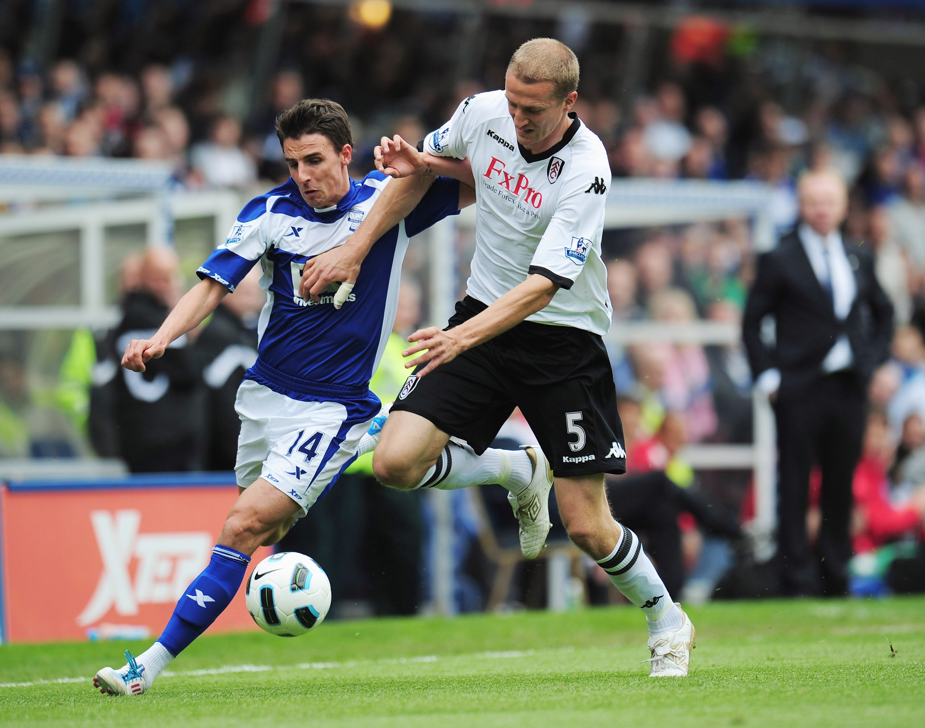 BIRMINGHAM, ENGLAND - MAY 15:  Matt Derbyshire of Birmingham City is challenged by Brede Hangeland of Fulham during the Barclays Premier League match between Birmingham City and Fulham at St. Andrews on May 15, 2011 in Birmingham, England.  (Photo by Shau