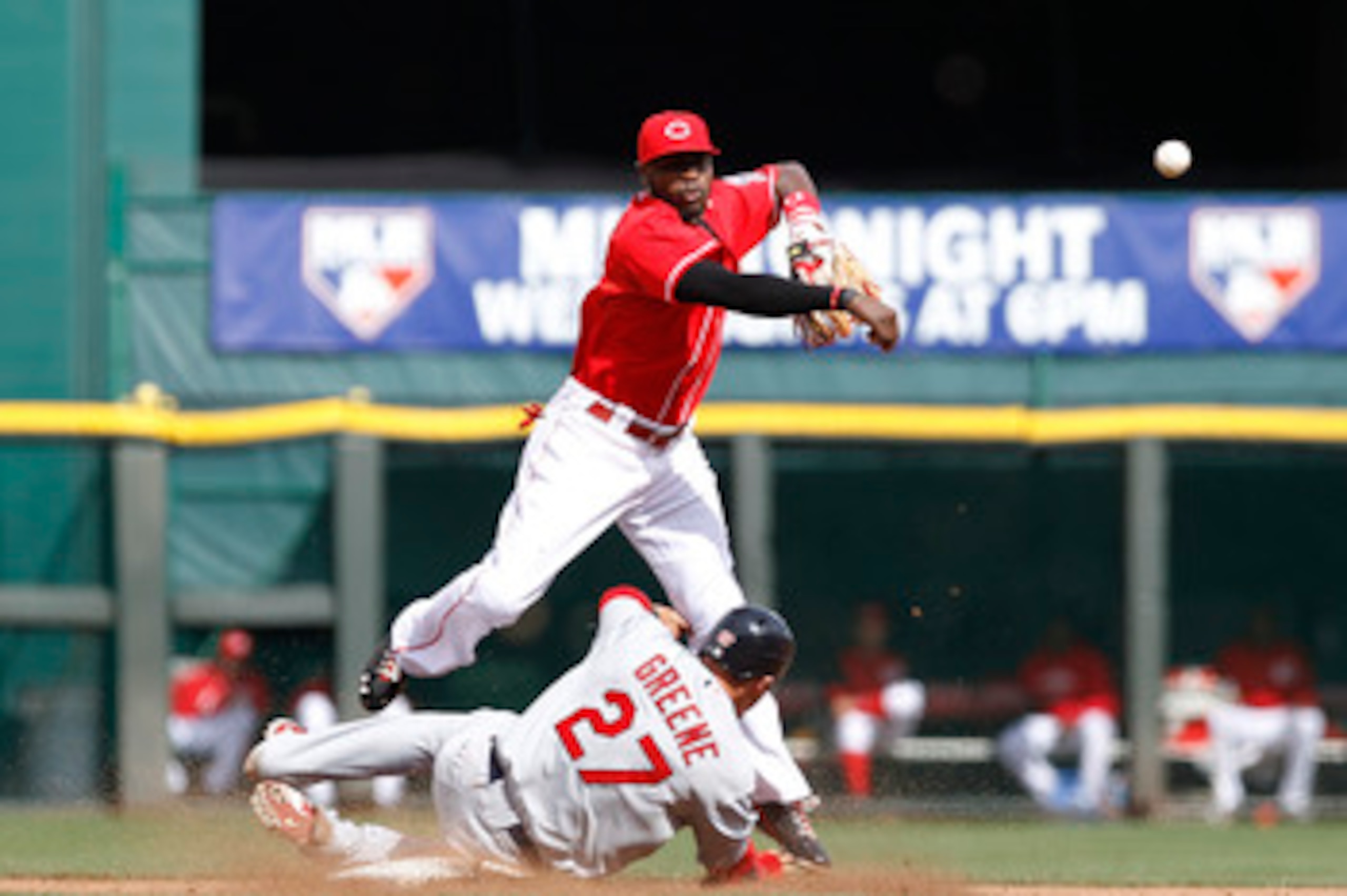 CINCINNATI, OH - MAY 14: Brandon Phillips #4 of the Cincinnati Reds turns a double play over Tyler Greene #27 of the St. Louis Cardinals at Great American Ball Park on May 14, 2011 in Cincinnati, Ohio. The Reds defeated the Cardinals 7-3. (Photo by Joe Ro
