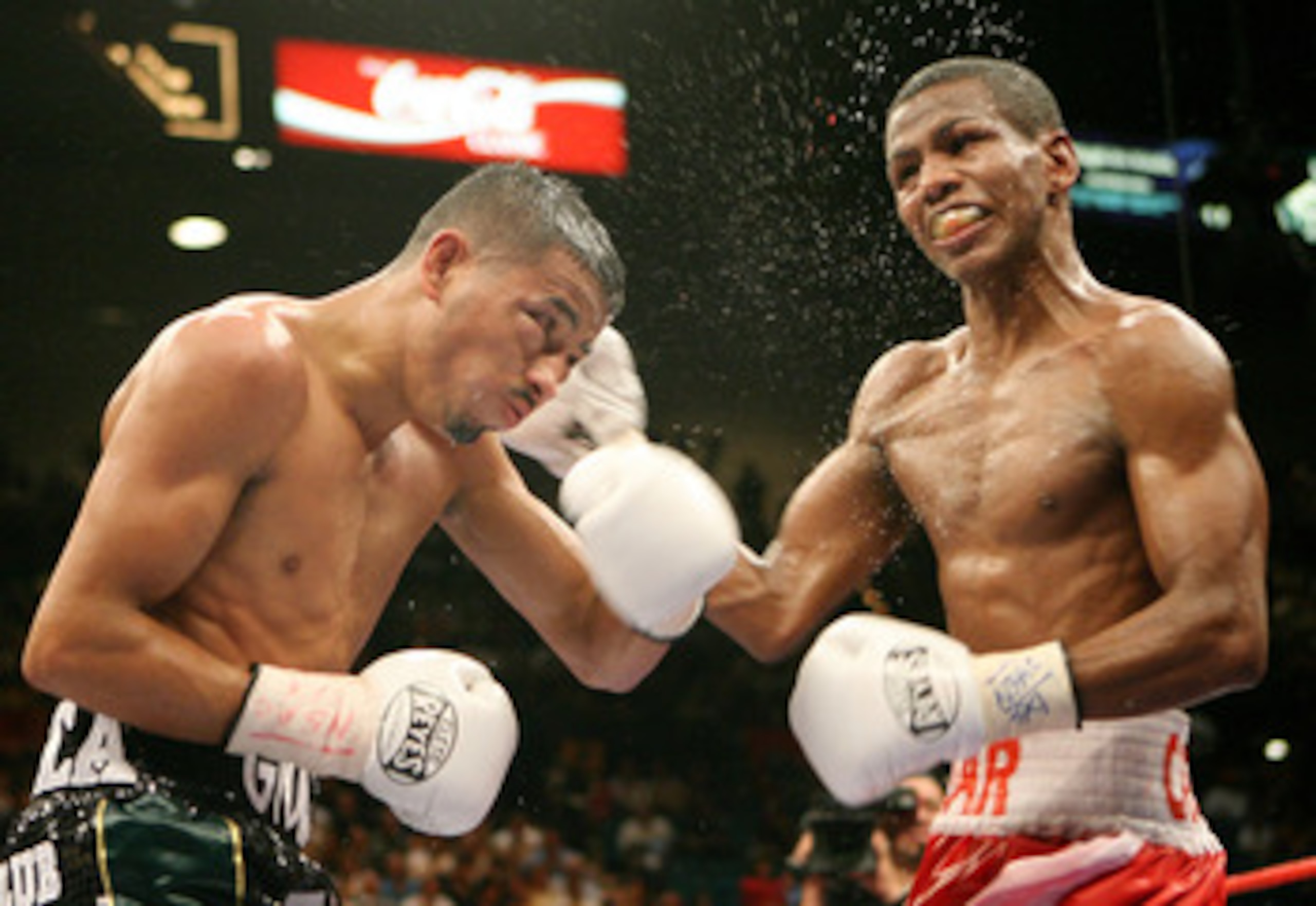 LAS VEGAS - JULY 26: Cesar Canchila (R) hits Giovani Segura during their interim WBA light flyweight title fight at the MGM Grand Garden Arena July 26, 2008 in Las Vegas, Nevada. Canchila won by unanimous decision. (Photo by Ethan Miller/Getty Images) LAS VEGAS - JULY 26: Cesar Canchila (R) hits Giovani Segura during their interim WBA light flyweight title fight at the MGM Grand Garden Arena July 26, 2008 in Las Vegas, Nevada. Canchila won by unanimous decision. (Photo by Ethan Miller/Getty Images)