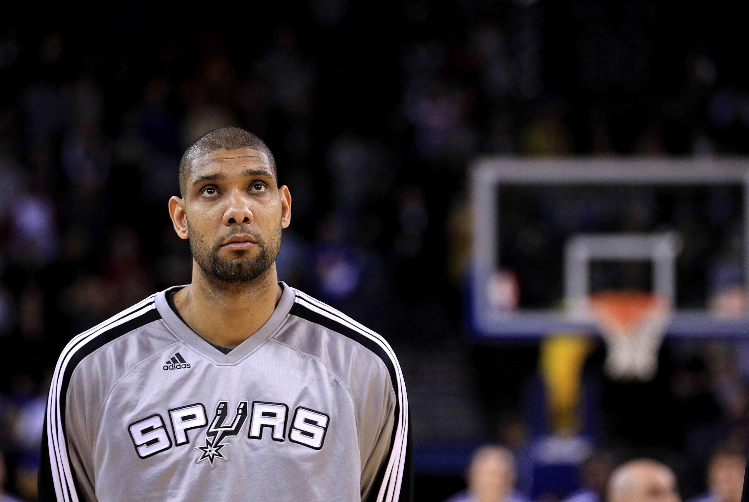 OAKLAND, CA - JANUARY 24:  Tim Duncan #21 of the San Antonio Spurs stands for the National Anthem before their game against the Golden State Warriors at Oracle Arena on January 24, 2011 in Oakland, California.  NOTE TO USER: User expressly acknowledges an