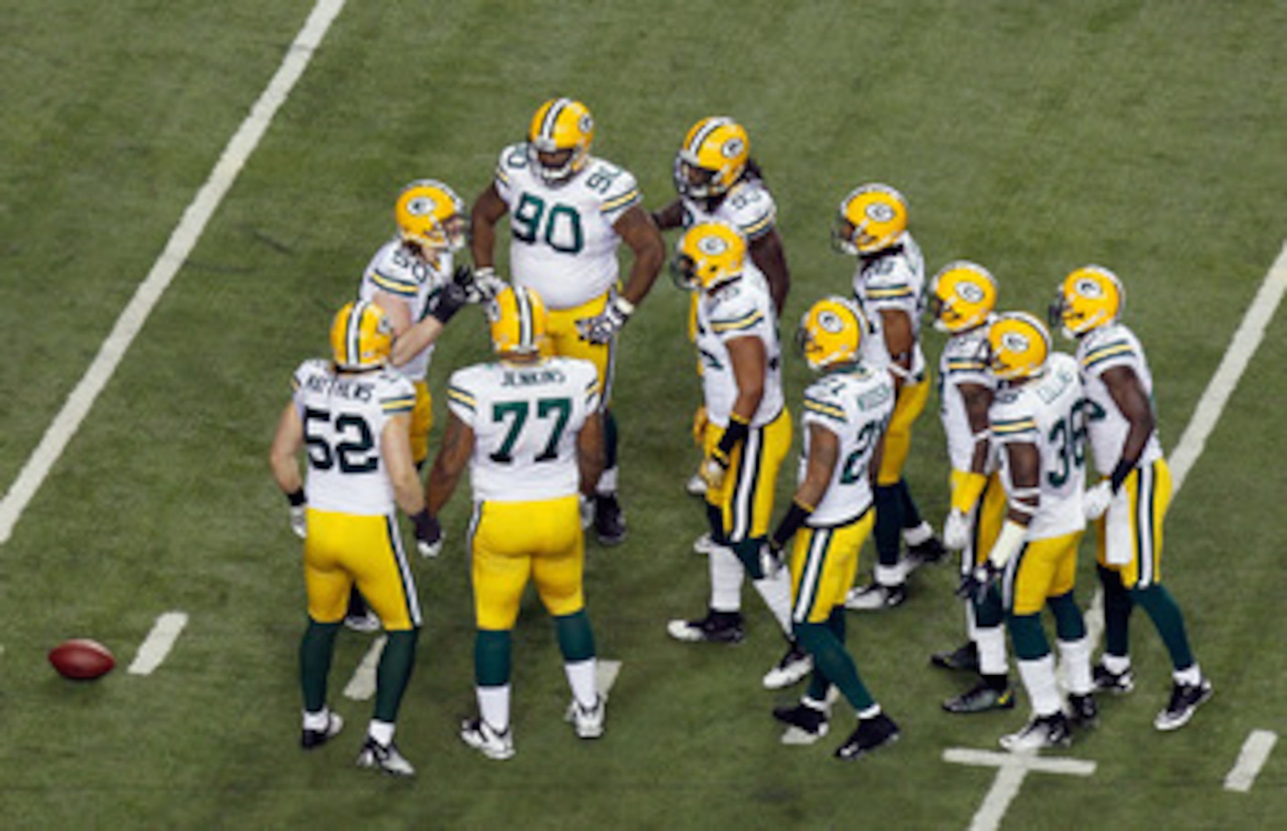 ATLANTA, GA - JANUARY 15:  A.J. Hawk #50 of the Green Bay Packers calls a play in the defensive huddle to teammates including Clay Matthews #52 and B.J. Raji #90 against the Atlanta Falcons during their 2011 NFC divisional playoff game at Georgia Dome on