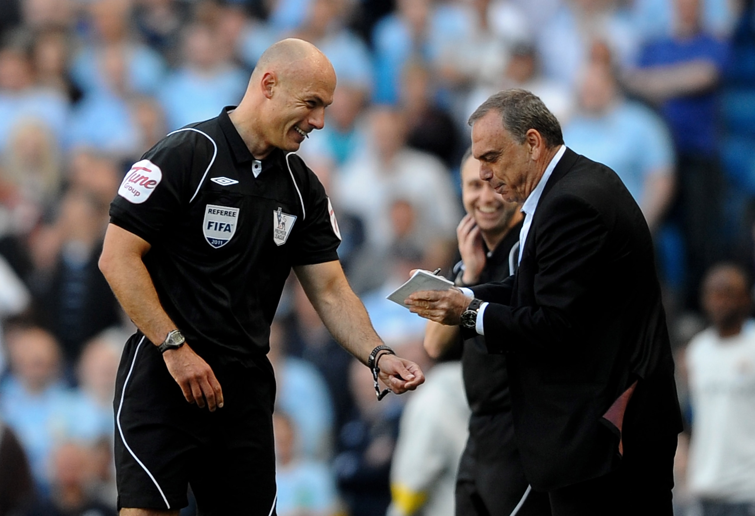 MANCHESTER, ENGLAND - MAY 01: West Ham United Manager Avram Grant pretends to sign an autograph for Referee Howard Webb after he dropped his notebook during the Barclays Premier League match between Manchester City and West Ham United at the City of Man MANCHESTER, ENGLAND - MAY 01: West Ham United Manager Avram Grant pretends to sign an autograph for Referee Howard Webb after he dropped his notebook during the Barclays Premier League match between Manchester City and West Ham United at the City of Man