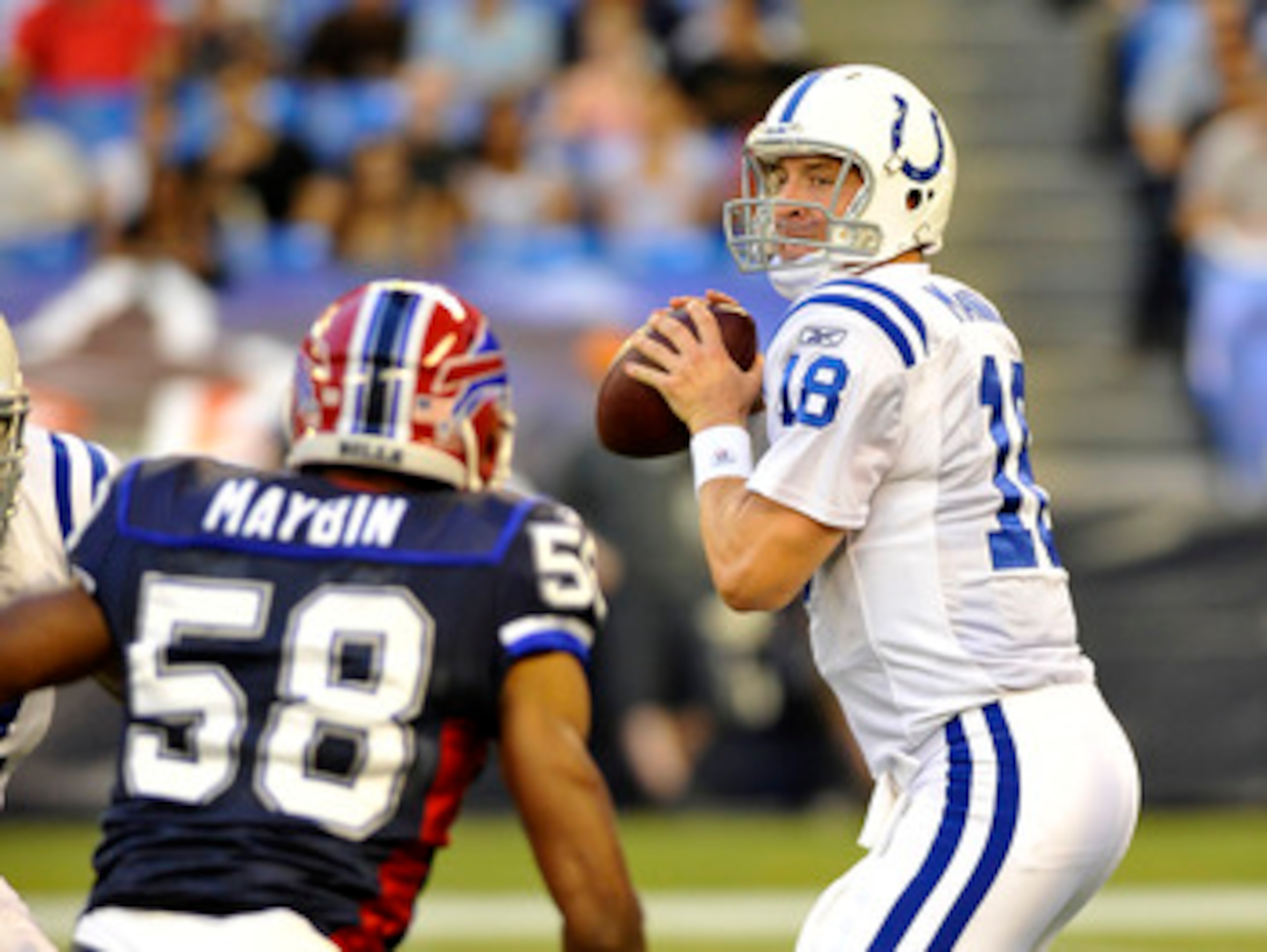 TORONTO, CANADA - AUGUST 19: Peyton Manning #18 of the Indianapolis Colts looks to pass the ball over a Aaron Maybin #58 of the Buffalo Bills during game action August 19, 2010 at the Rogers Centre in Toronto, Ontario, Canada. (Photo by Brad White/Getty I