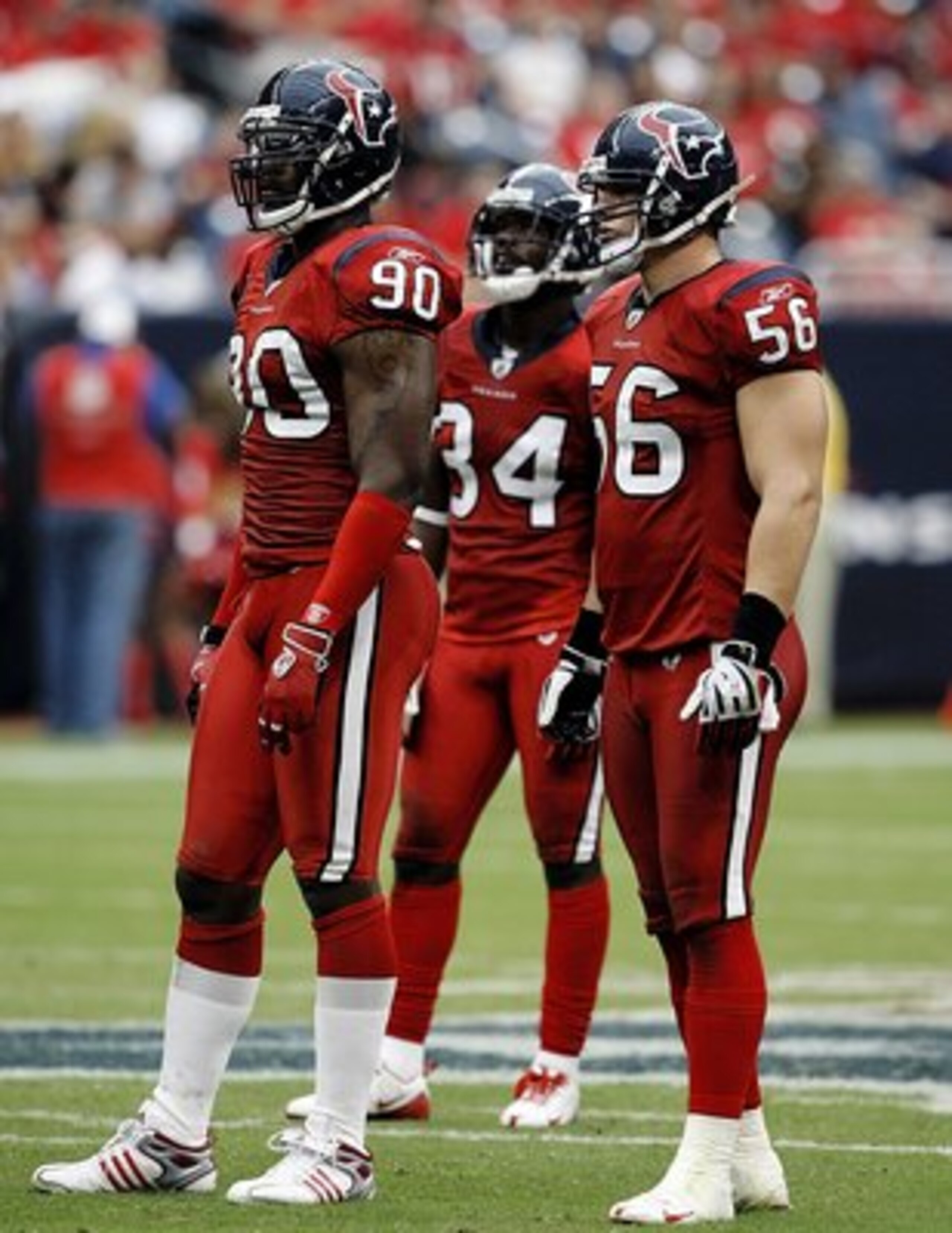 HOUSTON - SEPTEMBER 27:  Defensive end Mario Williams #90, strong safety Dominque Barber #34 and linebacker Brian Cushing #56 of the Houston Texans look on during the game against the Jacksonville Jaguars  at Reliant Stadium on September 27, 2009 in Houst