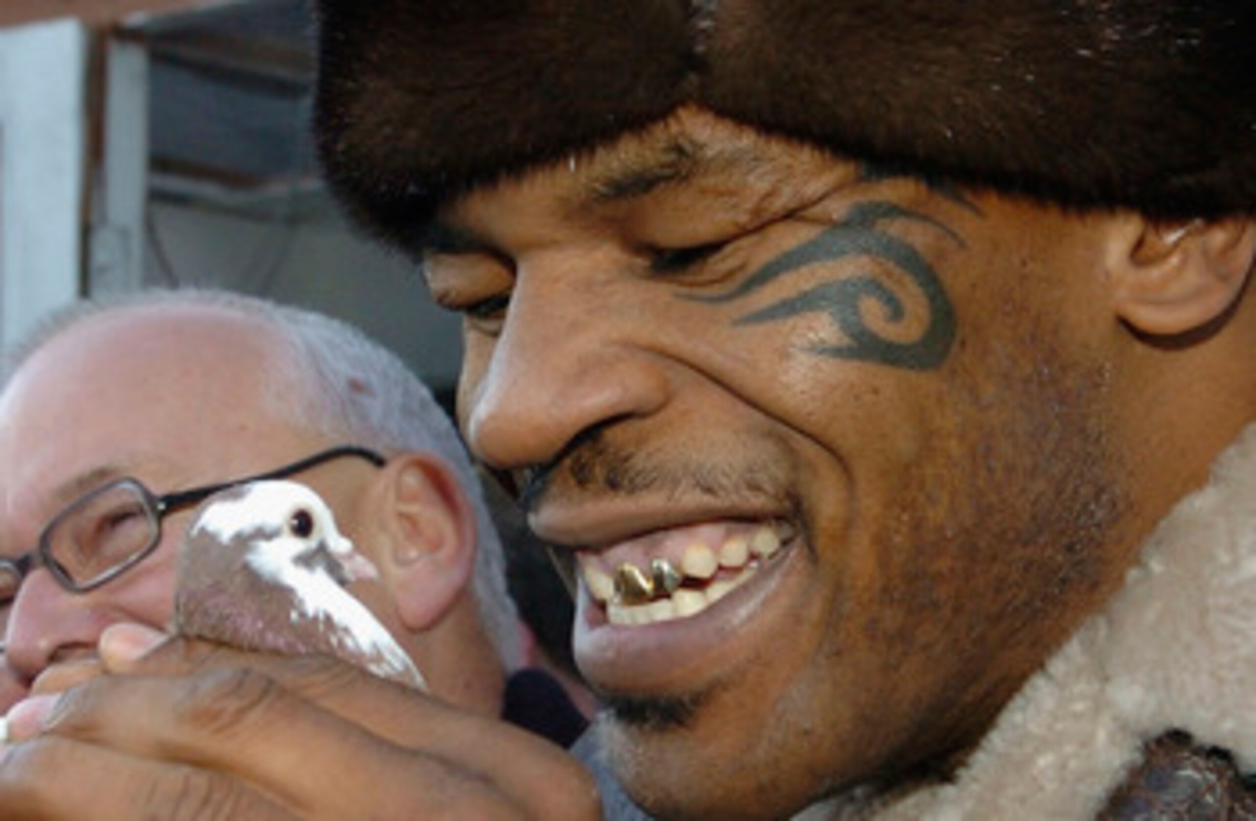 WALSALL, UNITED KINGDOM - NOVEMBER 18:  Former world heavyweight boxing champion Mike Tyson meets up with a pigeon fancier Horace Potts (L), of Bloxwich, Walsall, West Midlands on November 18, 2005 in Walsall, England. Tyson who is well known for his love