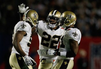 MIAMI GARDENS, FL - FEBRUARY 07:  Jonathan Vilma #51, Tracy Porter #22 and Roman Harper #41 of the New Orleans Saints celebrate after a play against the Indianapolis Colts during Super Bowl XLIV on February 7, 2010 at Sun Life Stadium in Miami Gardens, Fl