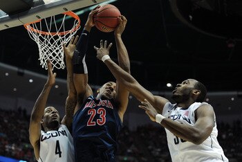 ANAHEIM, CA - MARCH 26:  Derrick Williams #23 of the Arizona Wildcats goes up for a rebound against Jamal Coombs-McDaniel #4 and Charles Okwandu #35 of the Connecticut Huskies during the west regional final of the 2011 NCAA men's basketball tournament at 