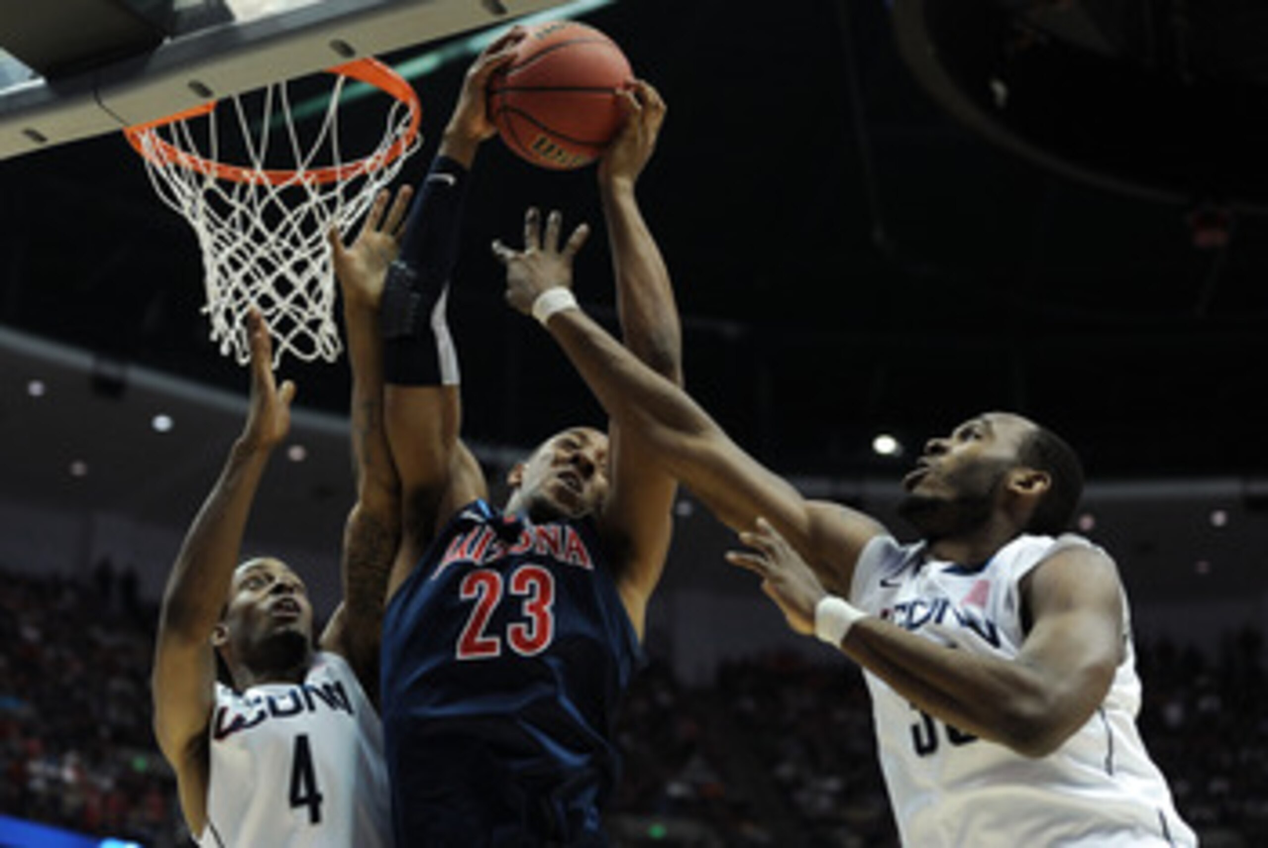ANAHEIM, CA - MARCH 26:  Derrick Williams #23 of the Arizona Wildcats goes up for a rebound against Jamal Coombs-McDaniel #4 and Charles Okwandu #35 of the Connecticut Huskies during the west regional final of the 2011 NCAA men's basketball tournament at 