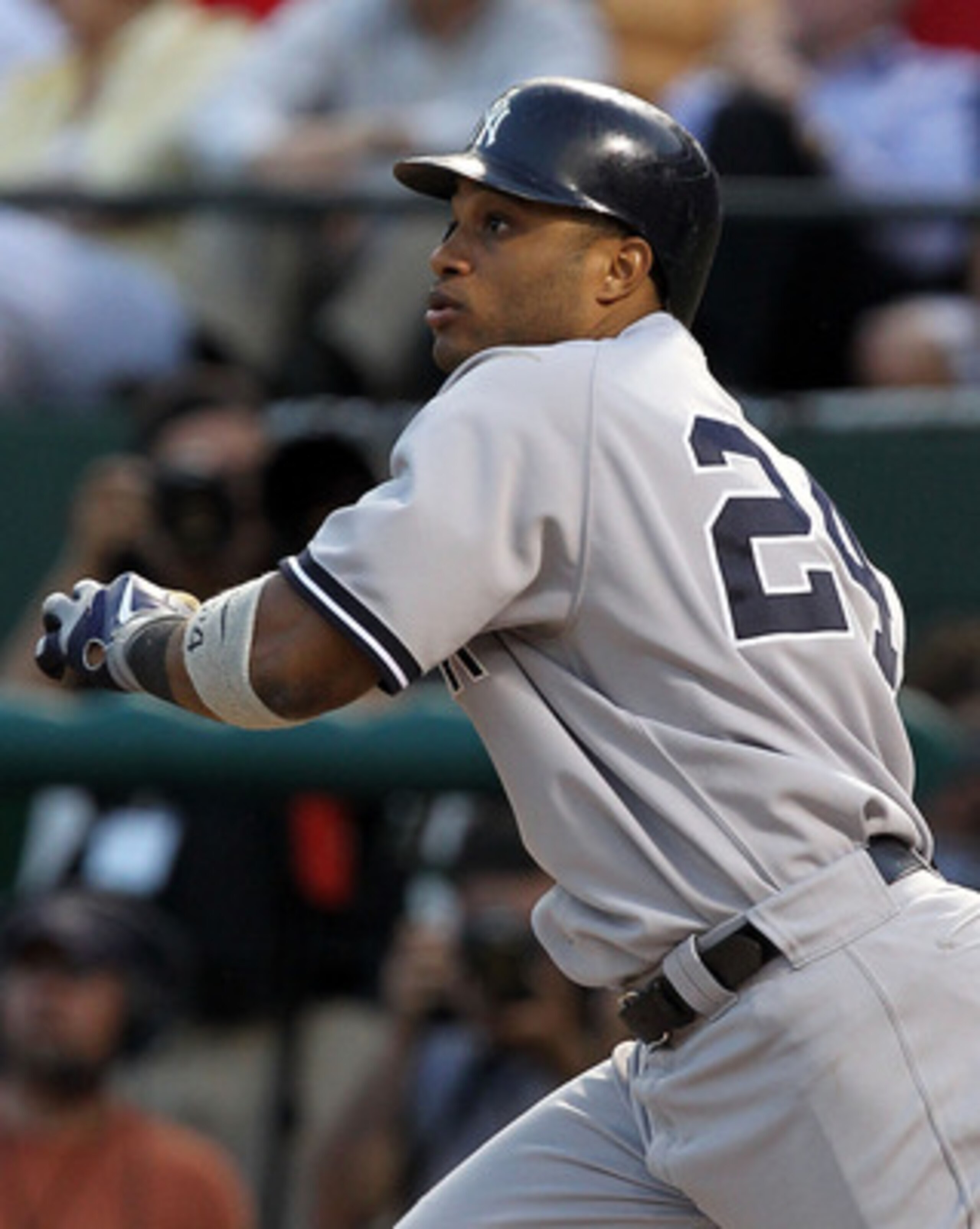 ARLINGTON, TX - MAY 07:  Robinson Cano #24 of the New York Yankees hits a three run triple against the Texas Rangers in the third inning at Rangers Ballpark in Arlington on May 7, 2011 in Arlington, Texas.  (Photo by Ronald Martinez/Getty Images)