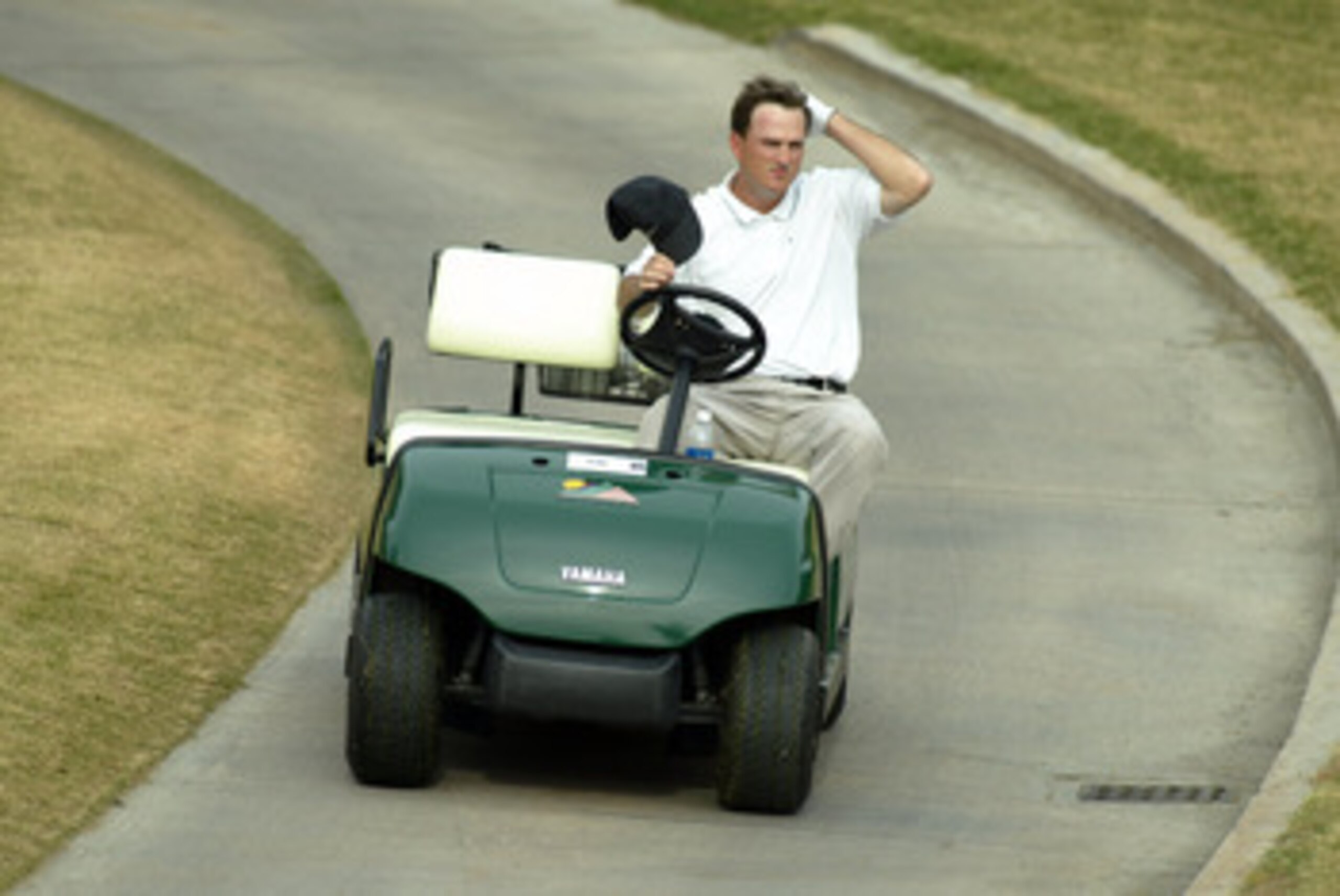LA QUINTA, CA - DECEMBER 9:  Casey Martin rides up a cart path during the final round of PGA Tour Qualifying on December 9, 2002 at PGA West in La Quinta, California. (Photo by Scott Halleran/Getty Images)