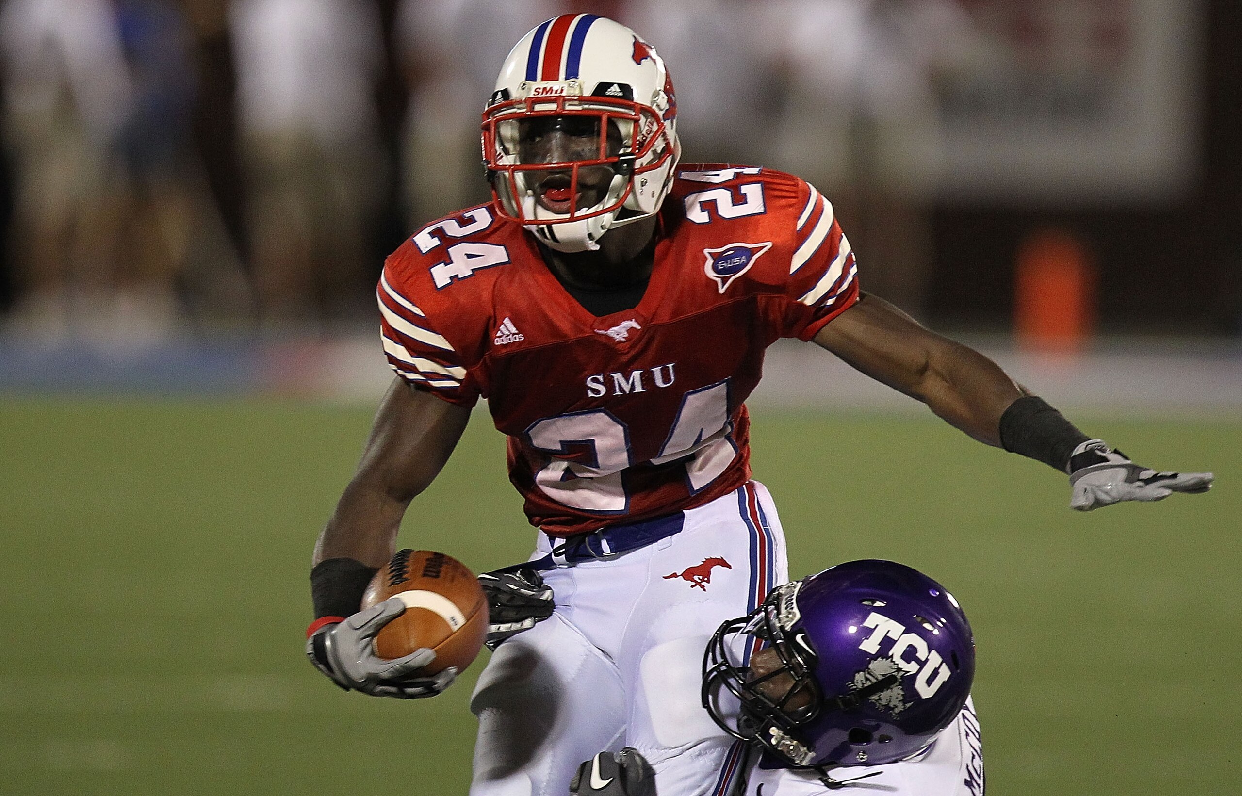 DALLAS - SEPTEMBER 24:  Wide receiver Aldrick Robinson #24 of the SMU Mustangs is tackled by Greg McCoy #7 of the TCU Horned Frogs at Gerald J. Ford Stadium on September 24, 2010 in Dallas, Texas.  (Photo by Ronald Martinez/Getty Images)