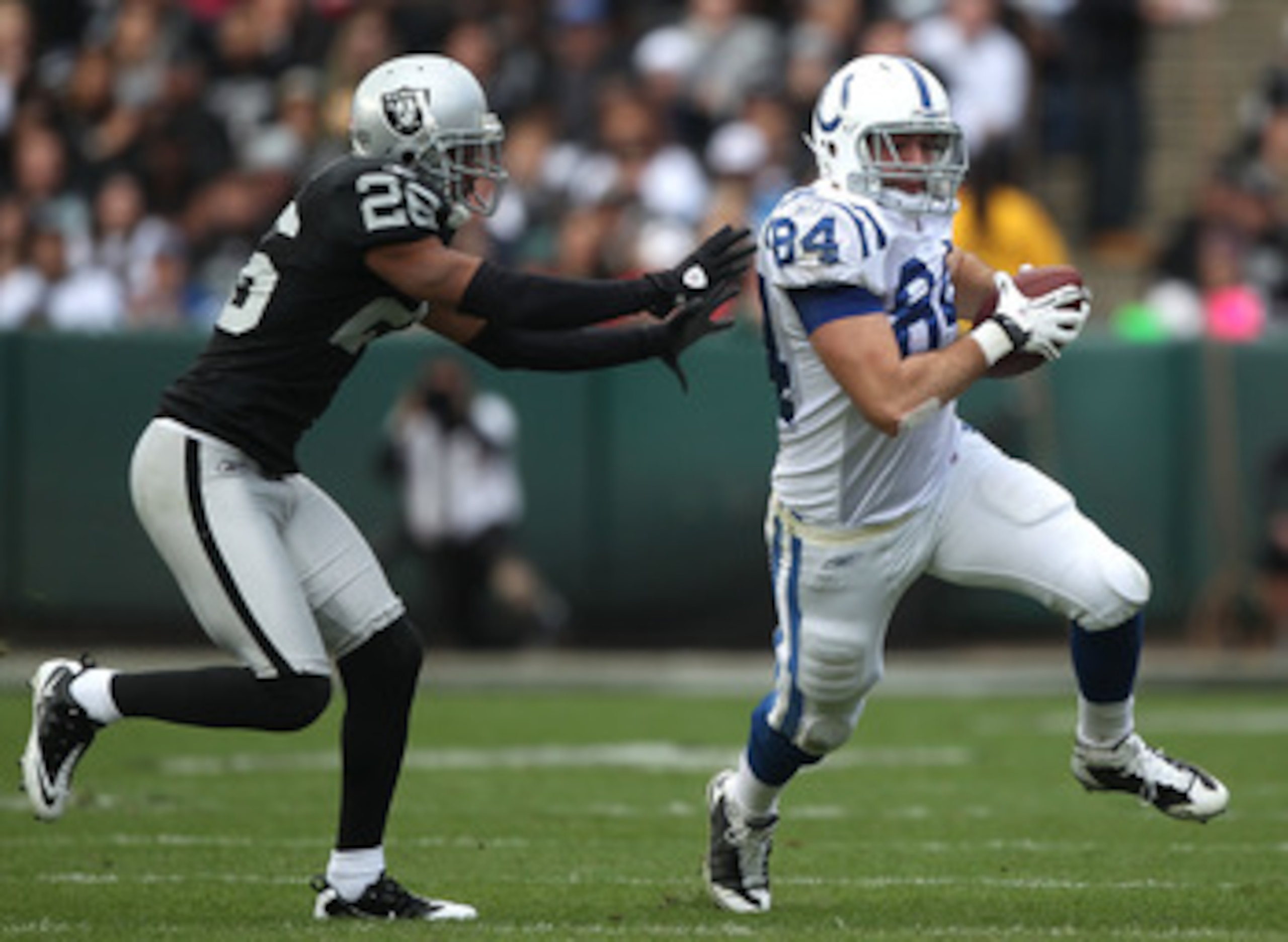 OAKLAND, CA - DECEMBER 26:  Jacob Tamme #84 of the Indianapolis Colts runs after a catch past Stanford Routt #26 of the Oakland Raiders during an NFL game at Oakland-Alameda County Coliseum on December  26, 2010 in Oakland, California.  (Photo by Jed Jaco