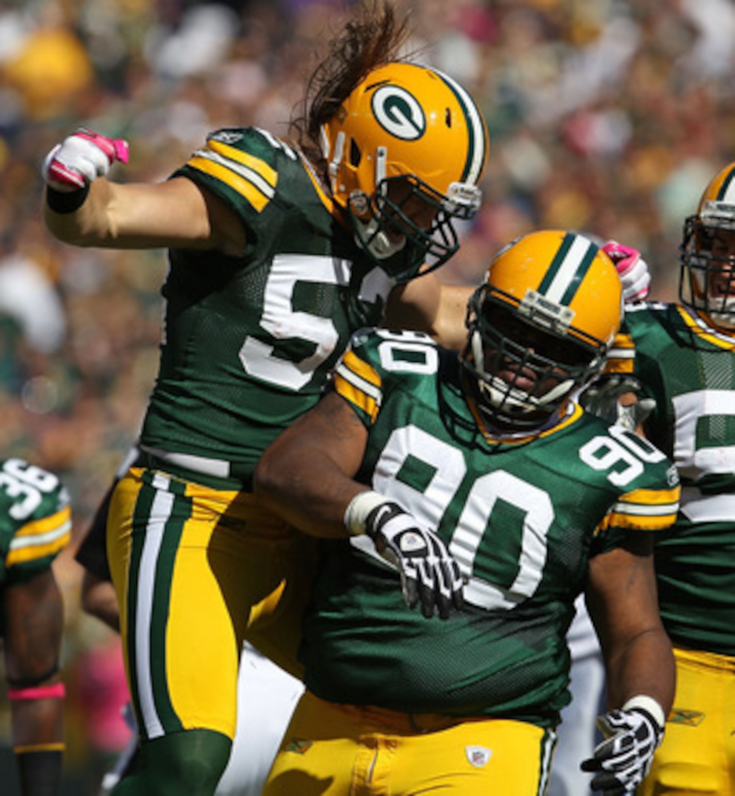 GREEN BAY, WI - OCTOBER 03: Clay Matthews #52 of the Green Bay Packers celebrates a sack by teammate B.J. Raji #90 against the Detroit Lions at Lambeau Field on October 3, 2010 in Green Bay, Wisconsin. The Packers defeated the Lions 28-26. (Photo by Jonat