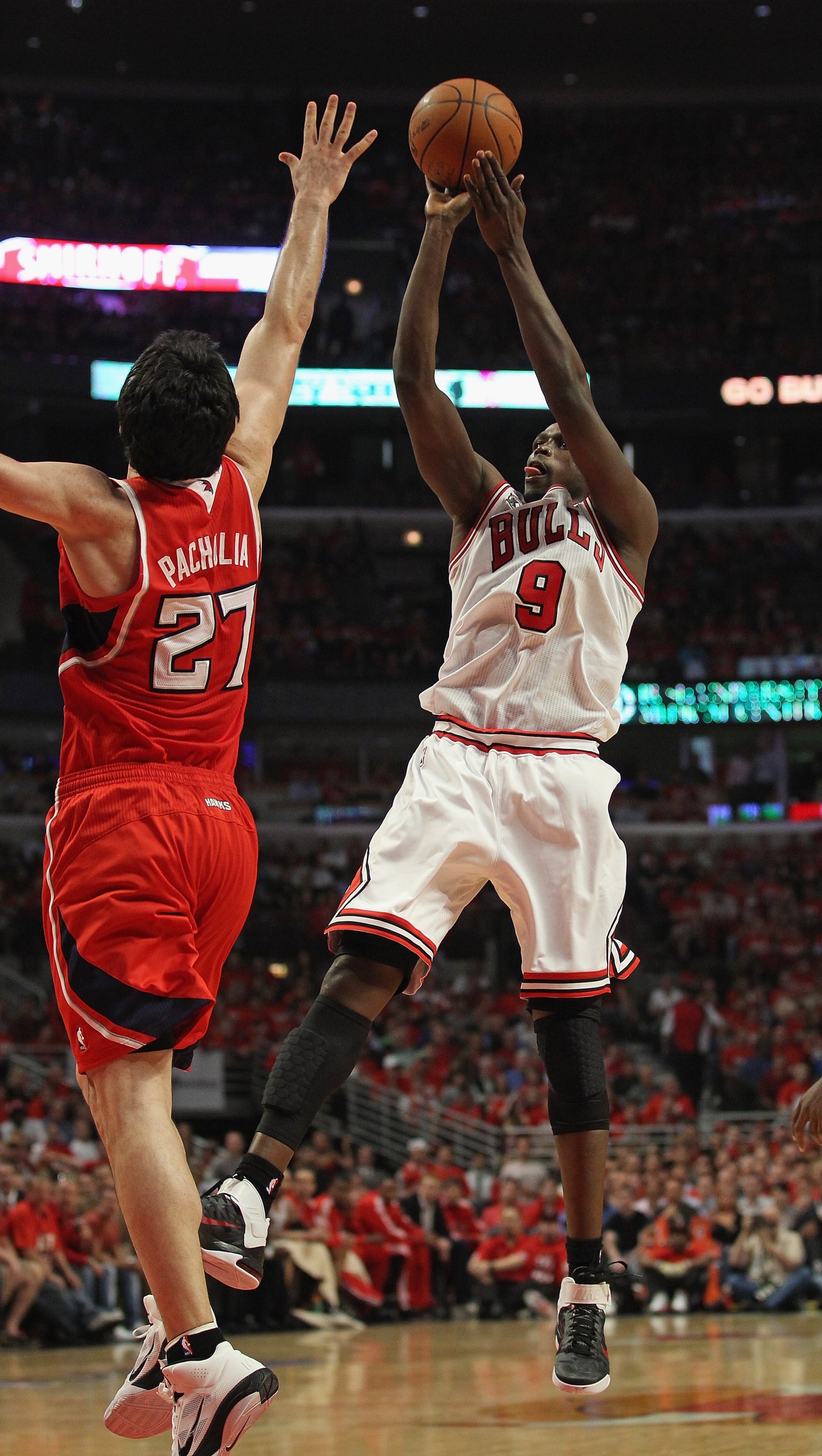 CHICAGO, IL - MAY 10: Loul Deng #9 of the Chicago Bulls puts up a shot against Zaza Pachulia #27 of the Atlanta Hawks in Game Five of the Eastern Conference Semifinals in the 2011 NBA Playoffs at the United Center on May 10, 2011 in Chicago, Illinois. The