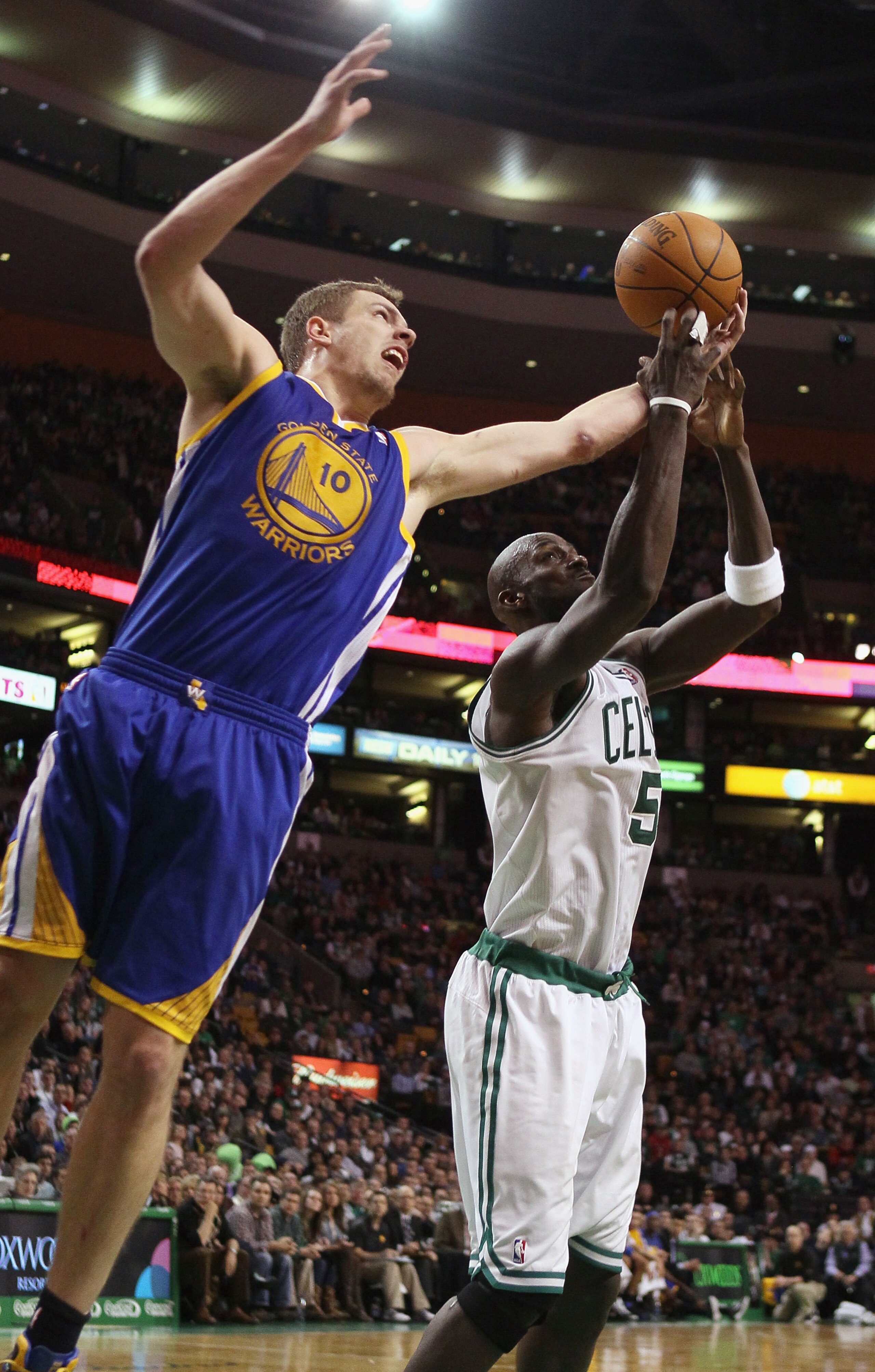 BOSTON, MA - MARCH 04:  Kevin Garnett #5 of the Boston Celtics and David Lee #10 of the Golden State Warriors fight for the rebound on March 4, 2011 at the TD Garden in Boston, Massachusetts.  The Celtics defeated the Warriors 107-103. NOTE TO USER: User