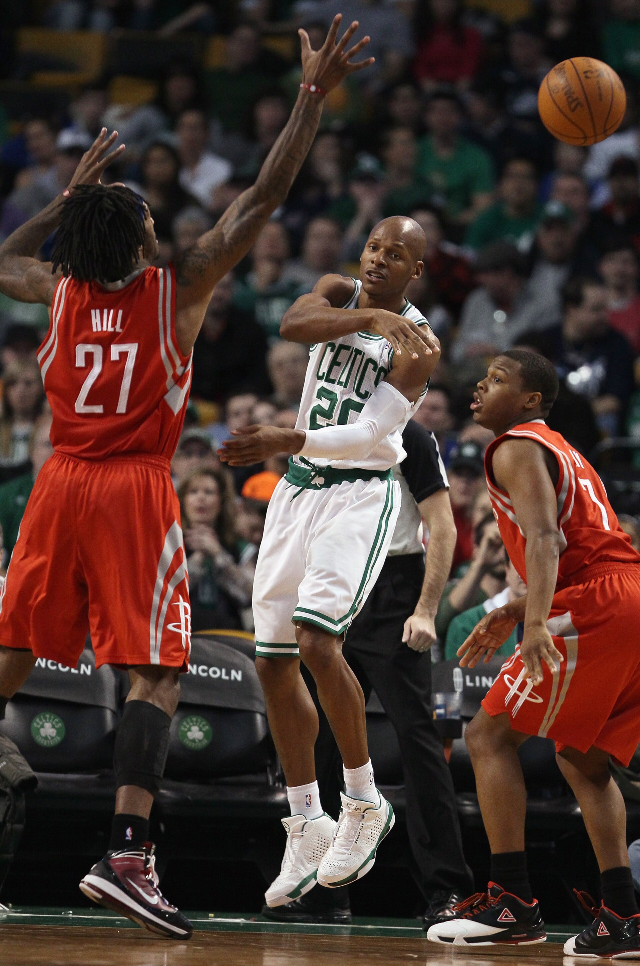 BOSTON, MA - JANUARY 10:  Ray Allen #20 of the Boston Celtics passes the ball as Kyle Lowry #7 and Jordan Hill #27 of the Houston Rockets defend on January 10, 2011 at the TD Garden in Boston, Massachusetts.  The Rockets defeated the Celtics 108-102. NOTE