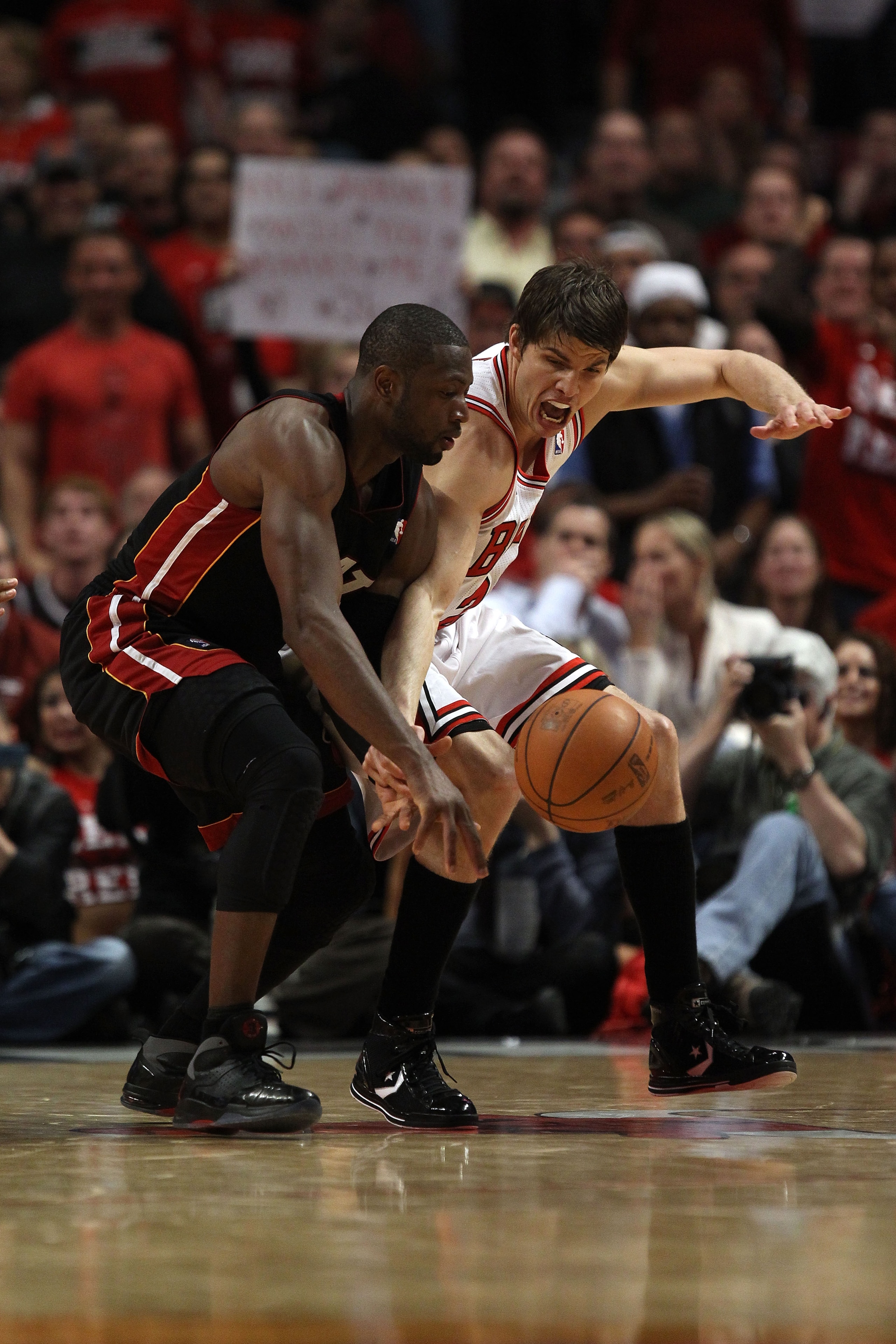 CHICAGO, IL - MAY 15:  Dwyane Wade #3 of the Miami Heat fights for a loose ball against Kyle Korver #26 of the Chicago Bulls in Game One of the Eastern Conference Finals during the 2011 NBA Playoffs on May 15, 2011 at the United Center in Chicago, Illinoi
