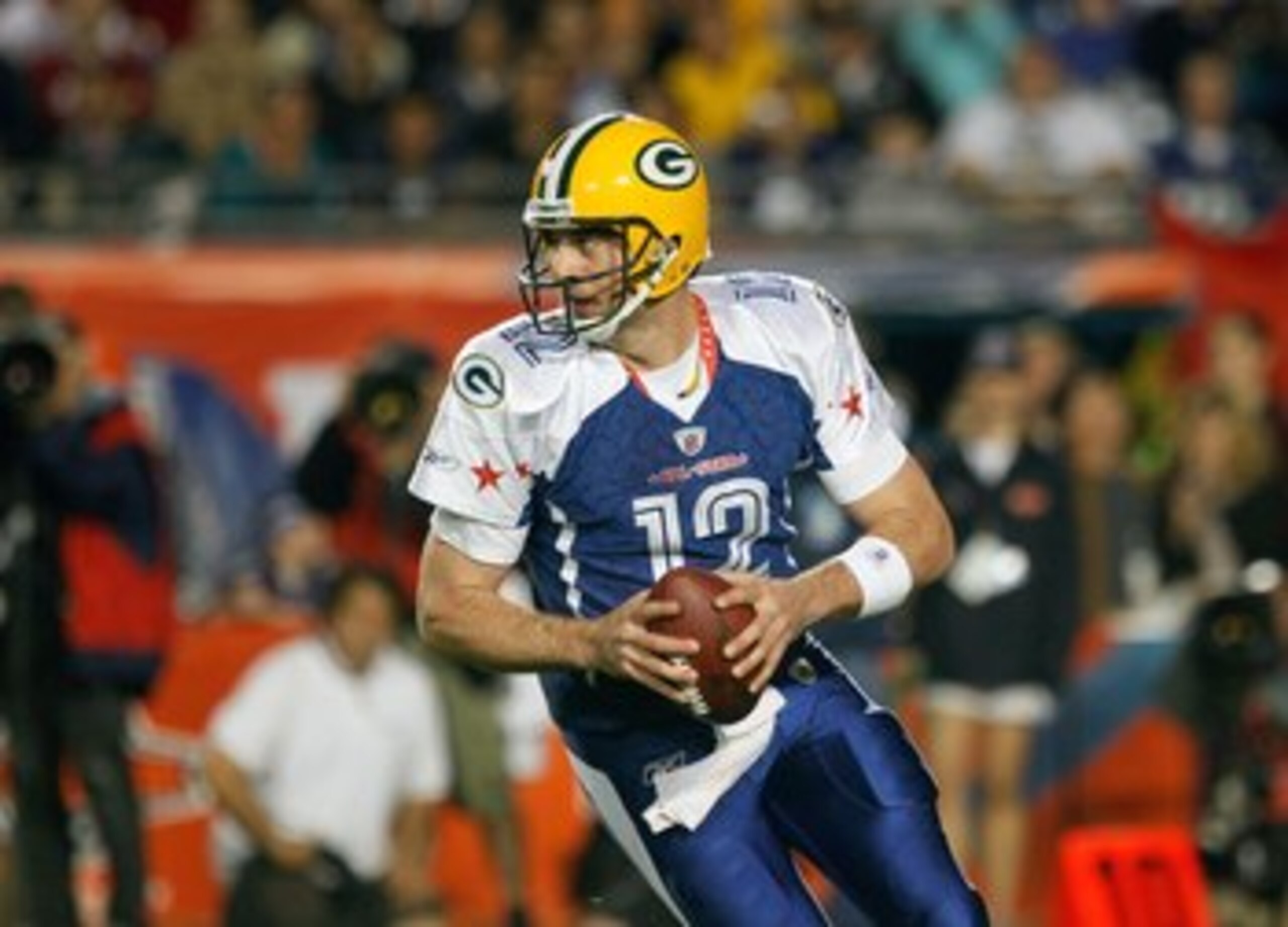 MIAMI GARDENS, FL - JANUARY 31:  Aaron Rodgers #12 of the NFC's Green Bay Packers scrambles out of the pocket during the 2010 AFC-NFC Pro Bowl game at Sun Life Stadium on January 31, 2010 in Miami Gardens, Florida. The AFC defeated the NFC 41-34. (Photo b