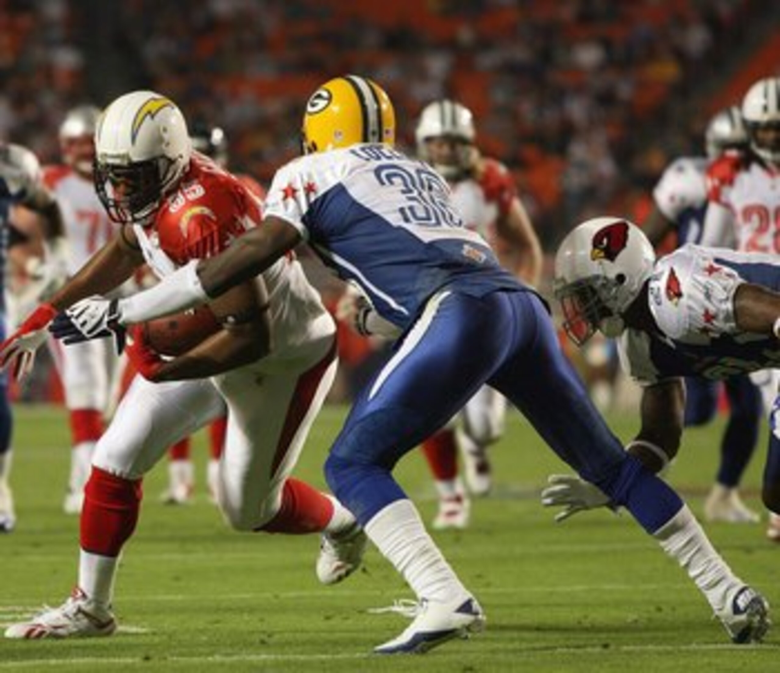 MIAMI GARDENS, FL - JANUARY 31: Antonio Gates #85 of the San Diego Chargers carries the ball against Nick Collins #36 of the Green Bay Packers during the 2010 AFC-NFC Pro Bowl at Sun Life Stadium on January 31, 2010 in Miami Gardens, Florida. (Photo by Do