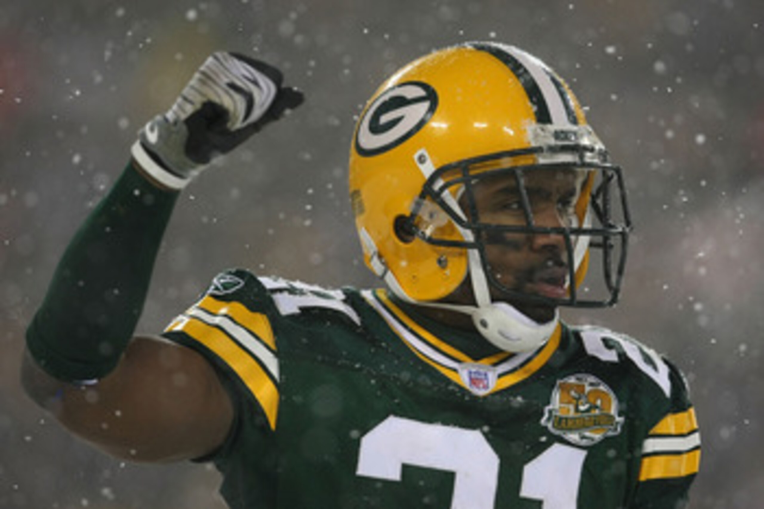 GREEN BAY, WI - JANUARY 12:  Cornerback Charles Woodson #21 of the Green Bay Packers celebrates in the final moments as the Packers defeated the Seattle Seahawks 42-20 during the NFC divisional playoff game on January 12, 2008 at Lambeau Field in Green Ba
