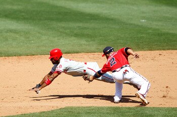 ATLANTA, GA - APRIL 10: Alex Gonzalez #2 of the Atlanta Braves tags out Ben Francisco #10 of the Philadelphia Phillies after he was caught stealing at Turner Field on April 10, 2011 in Atlanta, Georgia. The Phillies won 3-0. (Photo by Joe Robbins/Getty Im