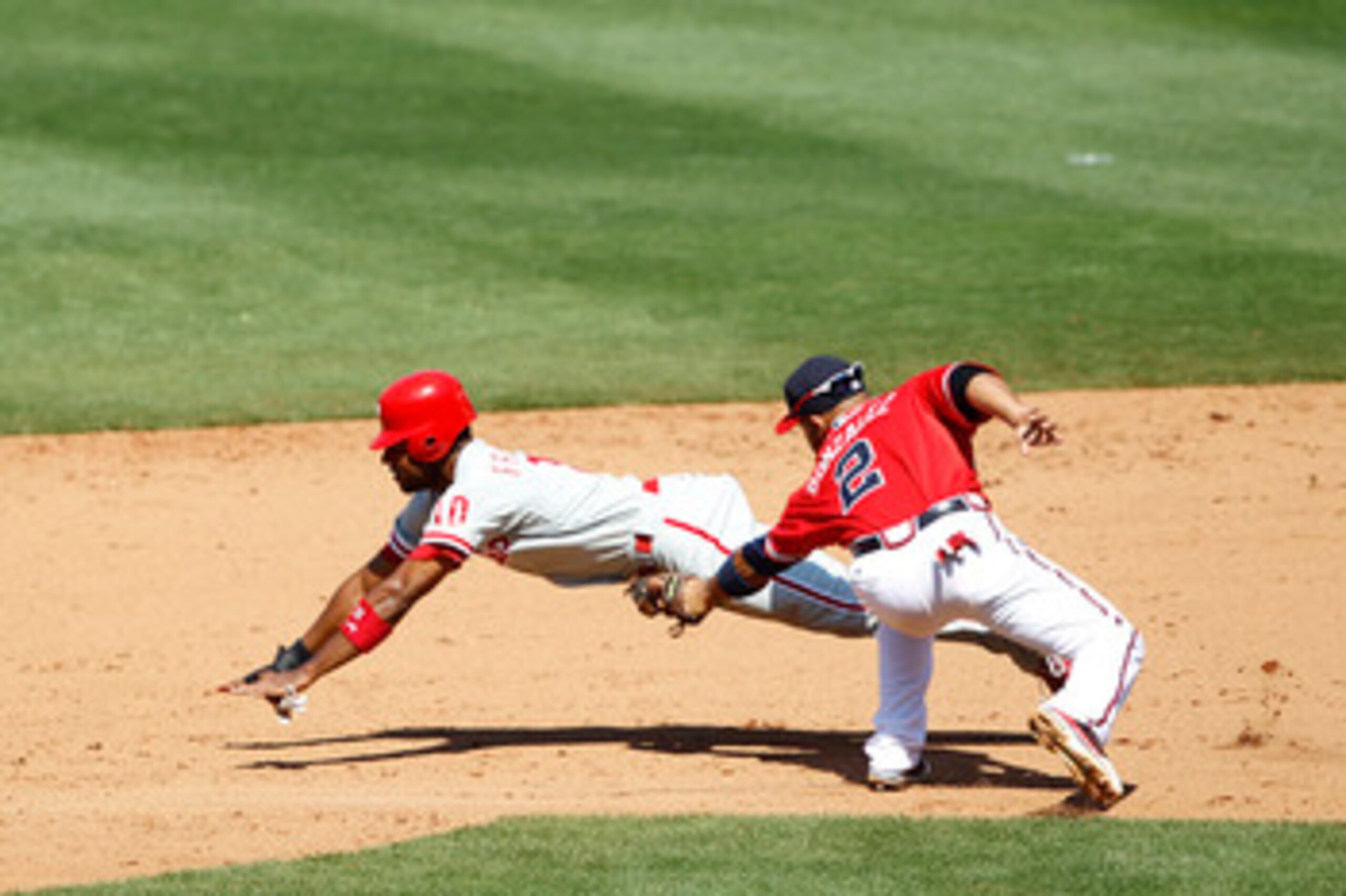 ATLANTA, GA - APRIL 10: Alex Gonzalez #2 of the Atlanta Braves tags out Ben Francisco #10 of the Philadelphia Phillies after he was caught stealing at Turner Field on April 10, 2011 in Atlanta, Georgia. The Phillies won 3-0. (Photo by Joe Robbins/Getty Im