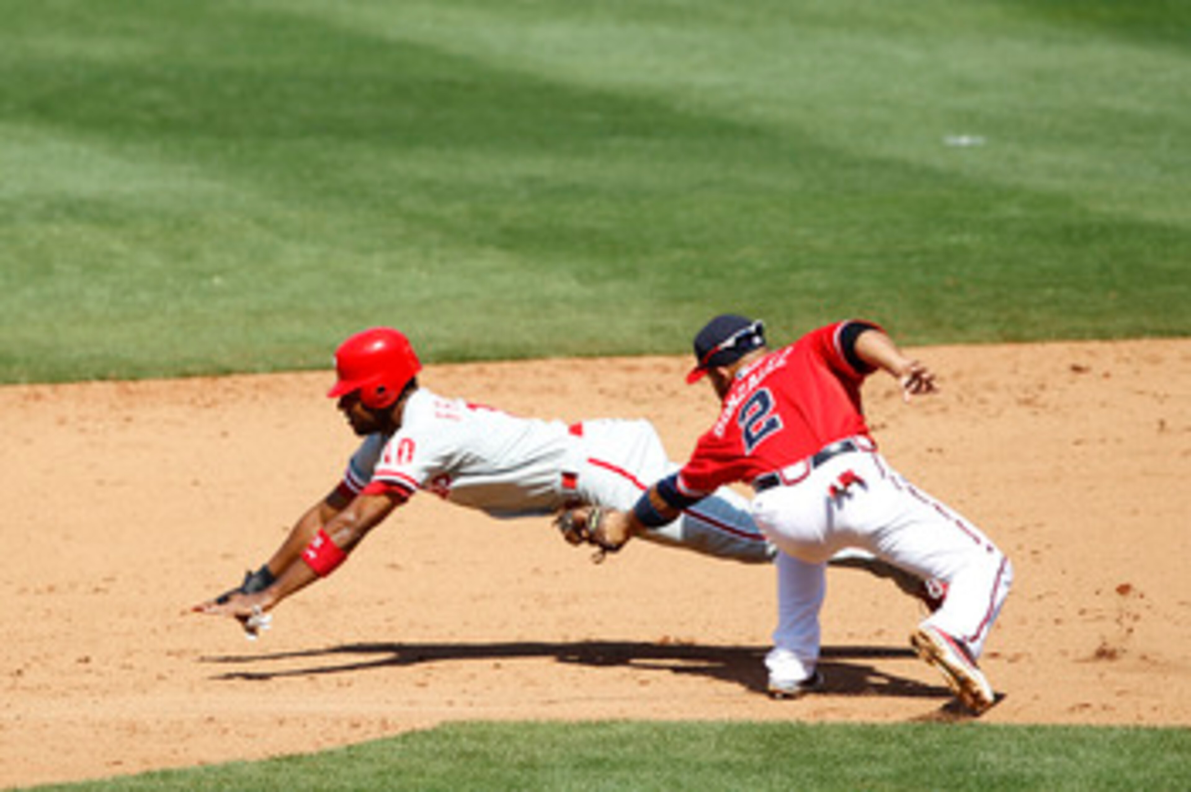 ATLANTA, GA - APRIL 10: Alex Gonzalez #2 of the Atlanta Braves tags out Ben Francisco #10 of the Philadelphia Phillies after he was caught stealing at Turner Field on April 10, 2011 in Atlanta, Georgia. The Phillies won 3-0. (Photo by Joe Robbins/Getty Im