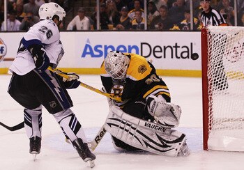 BOSTON, MA - MAY 14:  Tim Thomas #30 of the Boston Bruins blocks a shot by Martin St. Louis #26 of the Tampa Bay Lightning in the second period of Game One of the Eastern Conference Finals during the 2011 NHL Stanley Cup Playoffs at TD Garden on May 14, 2