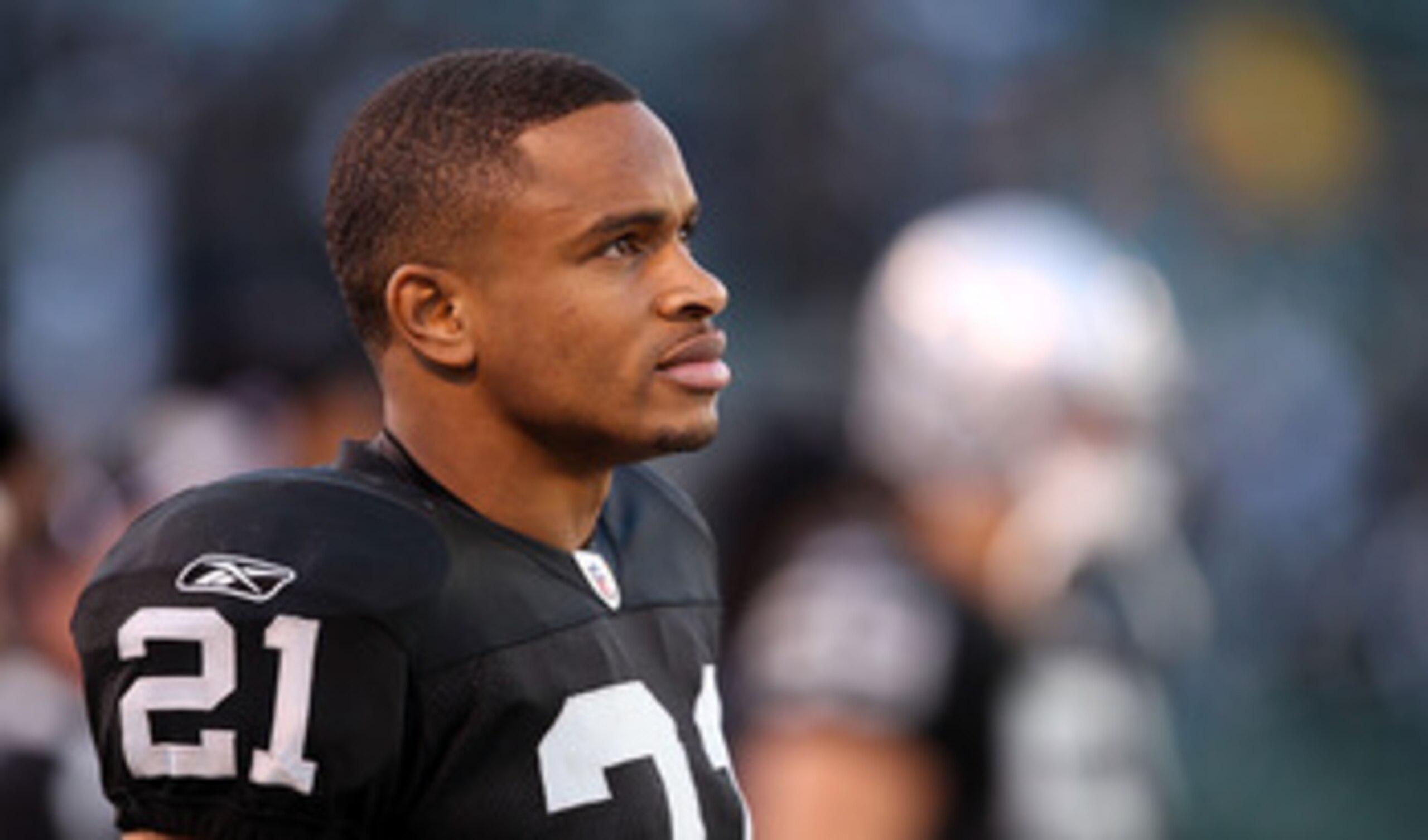 OAKLAND, CA - NOVEMBER 28:  Nnamdi Asomugha #21 of the Oakland Raiders stands on the sidelines during the closing minutes of their loss to the Miami Dolphins at Oakland-Alameda County Coliseum on November 28, 2010 in Oakland, California.  (Photo by Ezra S