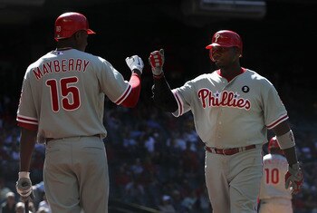 PHOENIX, AZ - APRIL 27:  Ryan Howard #6 of the Philadelphia Phillies high fives teammate John Mayberry #15 after scoring against the Arizona Diamondbacks during the Major League Baseball game at Chase Field on April 27, 2011 in Phoenix, Arizona.  The Phil