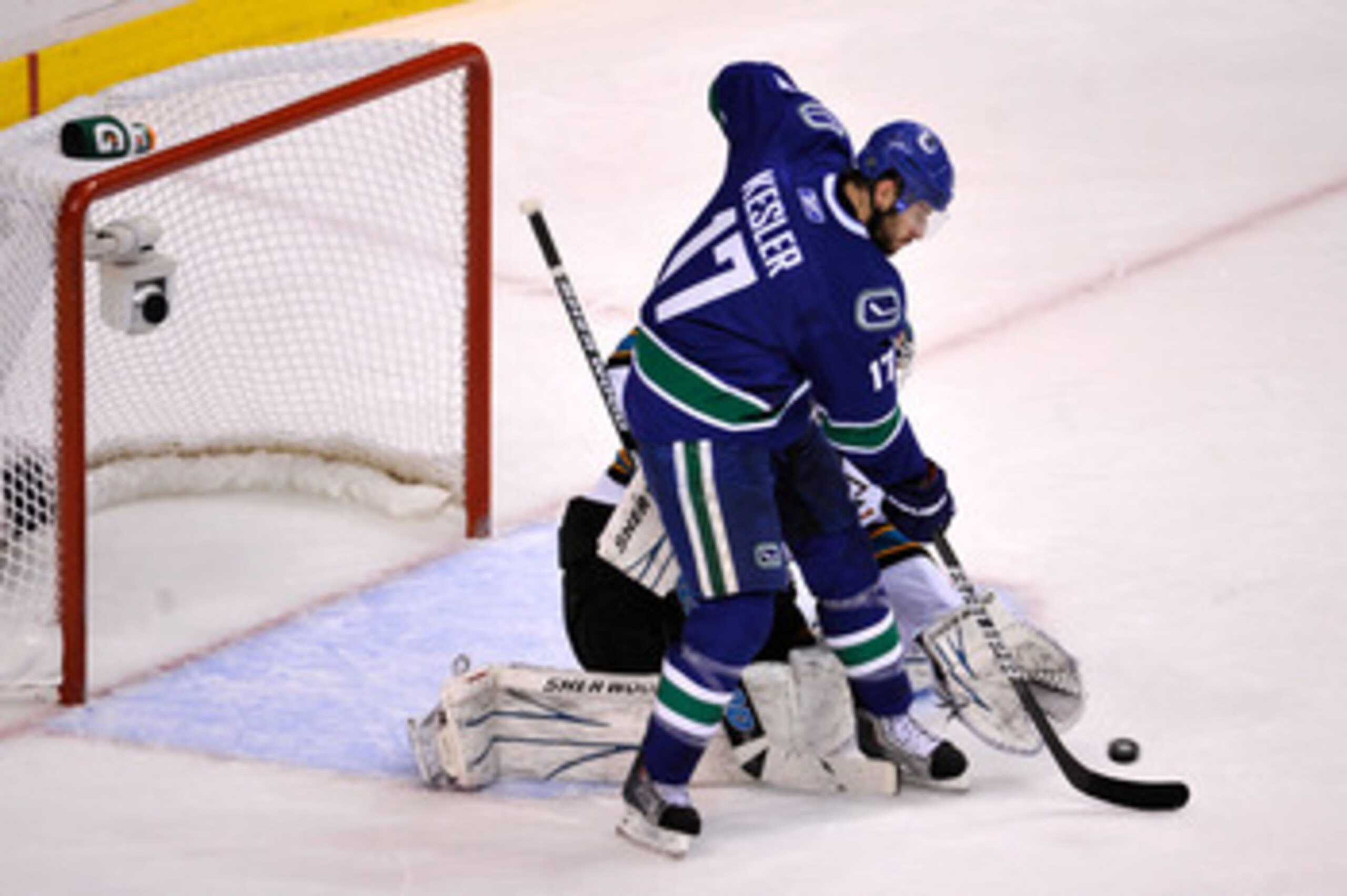 VANCOUVER, BC - MAY 15:  Ryan Kesler #17 of the Vancouver Canucks tries to deflect the puck in front of goaltender Antti Niemi #31 of the San Jose Sharks in Game One of the Western Conference Finals during the 2011 Stanley Cup Playoffs at Rogers Arena on 