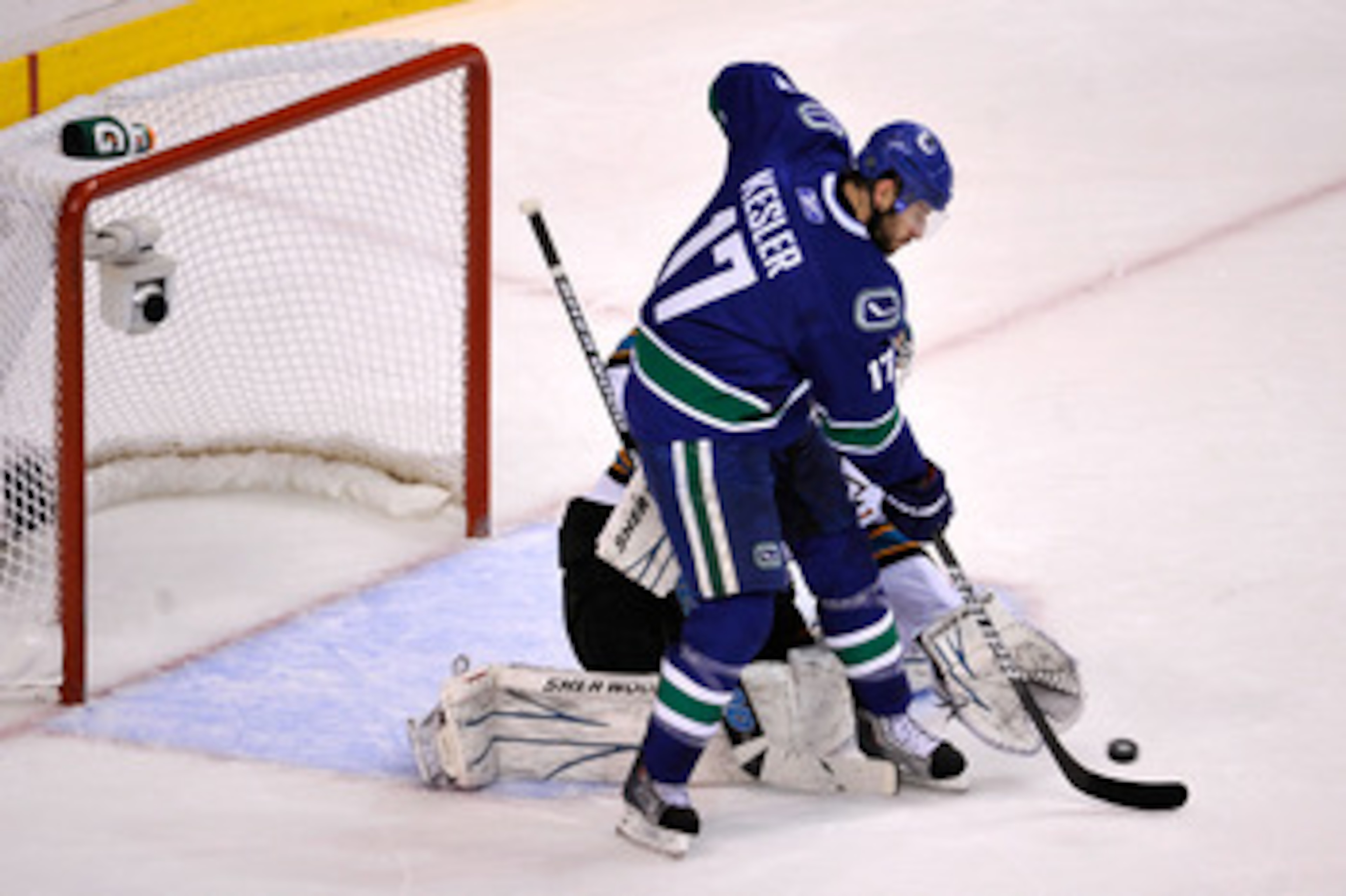 VANCOUVER, BC - MAY 15:  Ryan Kesler #17 of the Vancouver Canucks tries to deflect the puck in front of goaltender Antti Niemi #31 of the San Jose Sharks in Game One of the Western Conference Finals during the 2011 Stanley Cup Playoffs at Rogers Arena on 