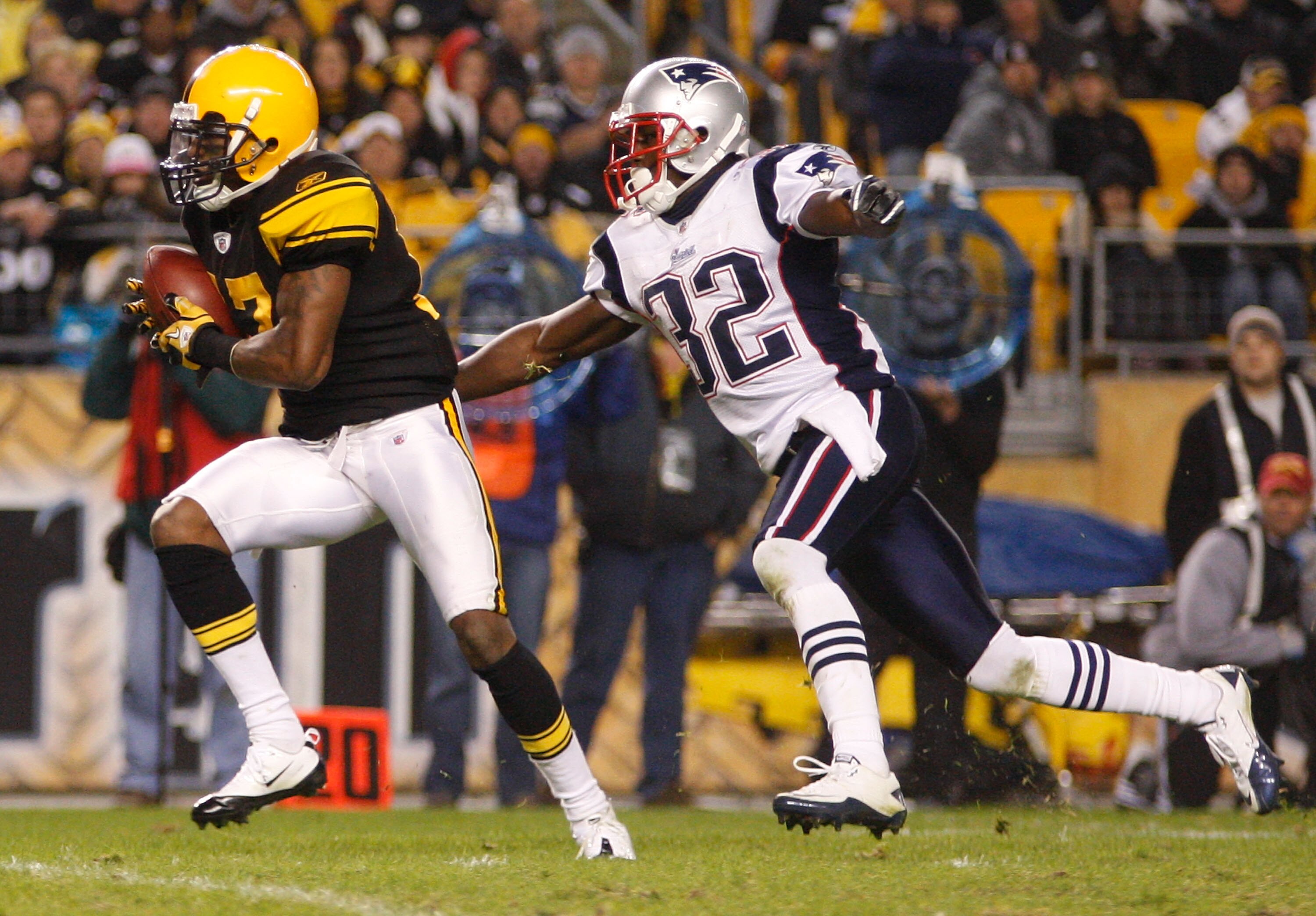 PITTSBURGH, PA - NOVEMBER 14:  Mike Wallace #17 of the Pittsburgh Steelers attempts to run from Devin McCourty #32 of the New England Patriots during the game on November 14, 2010 at Heinz Field in Pittsburgh, Pennsylvania.  (Photo by Jared Wickerham/Gett
