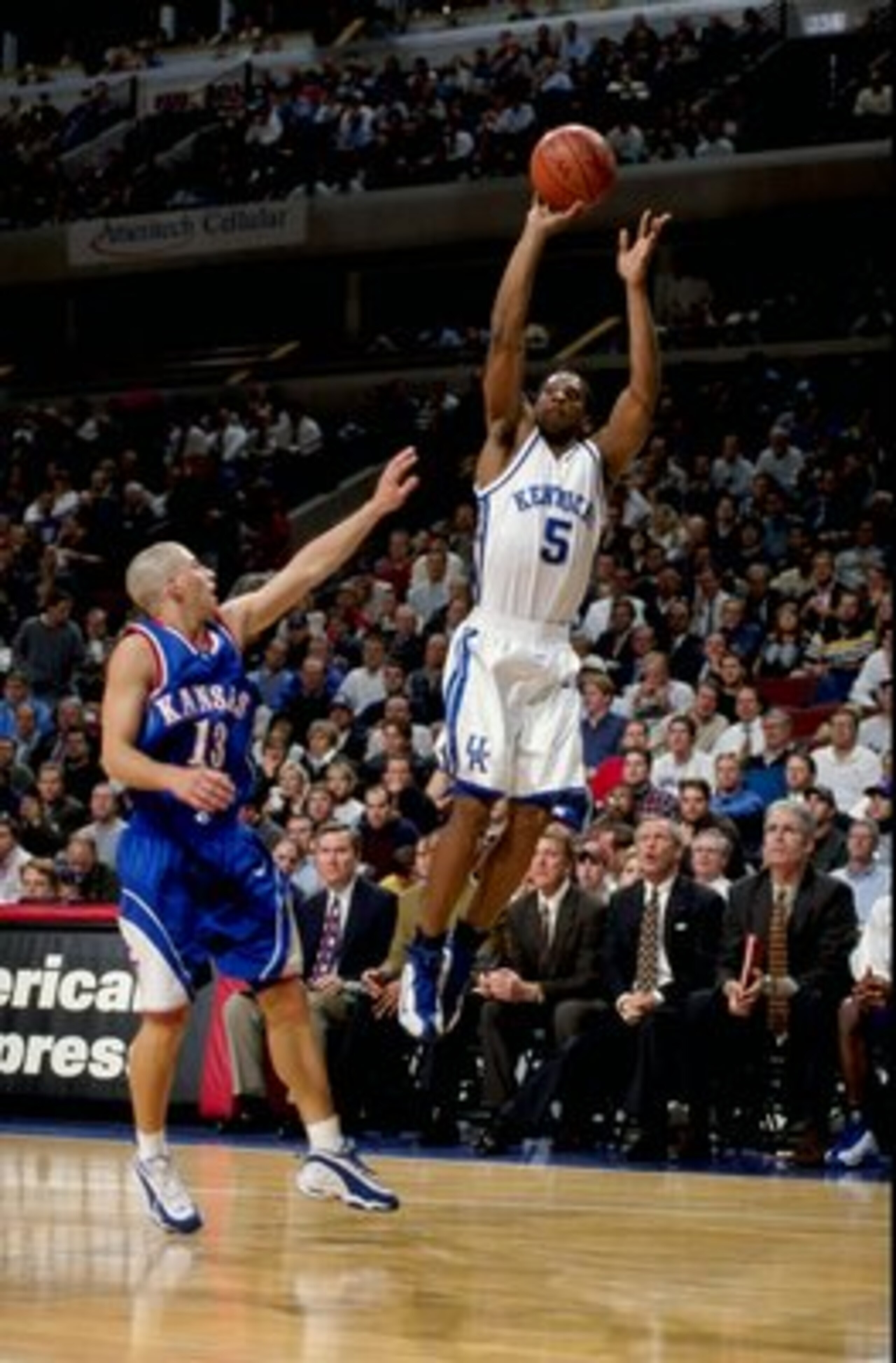 Wayne Turner #5 of the Kentucky Wildcats shoots as Jeff Boschee #13 of the Kansas Jayhawks blocks at the United Center in Chicago, Illinois. Kentucky defeated Kansas 63-45.